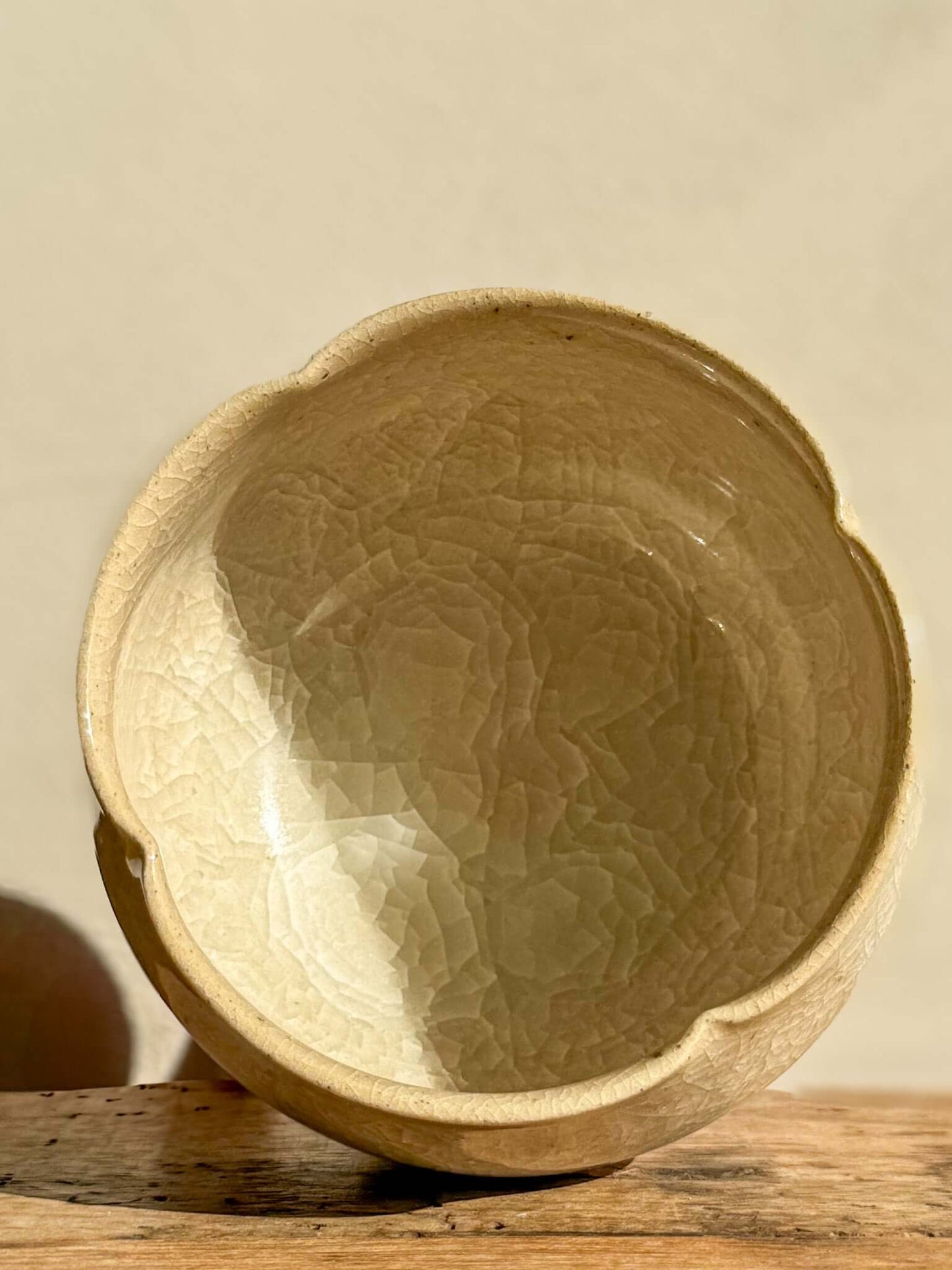 Yunomi Cup Kannyū Series #01 with crackle glaze, showcasing delicate patterns and softly flowing rim, on a wooden surface.