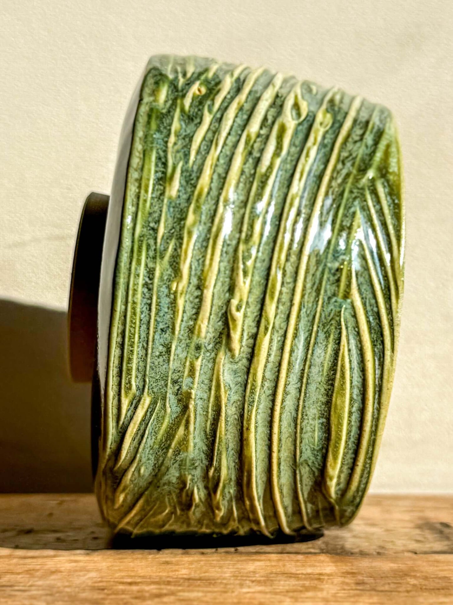 Wasabi Green Matcha Bowl with textured lines and glossy glaze, capturing light and creating a sense of movement and quiet energy.