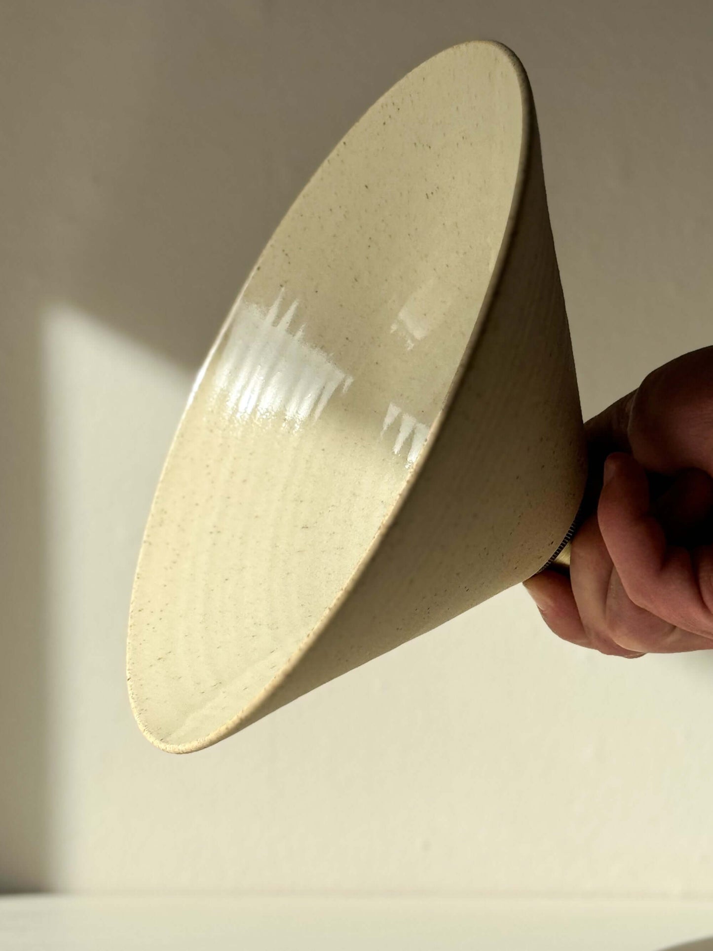 Ceramic lamp shade half clear glaze with matte exterior and glossy interior, showcasing a hand-thrown design for warm, cozy lighting.