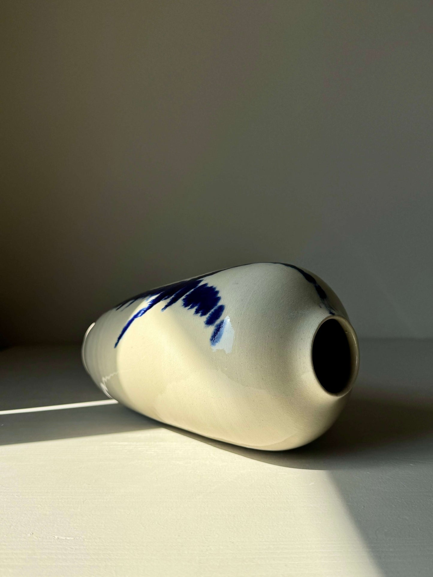Ceramic vase from Gosu Series #11, featuring hand-splashed cobalt blue on a glossy clear glaze, 20 cm tall, modern and unique design.