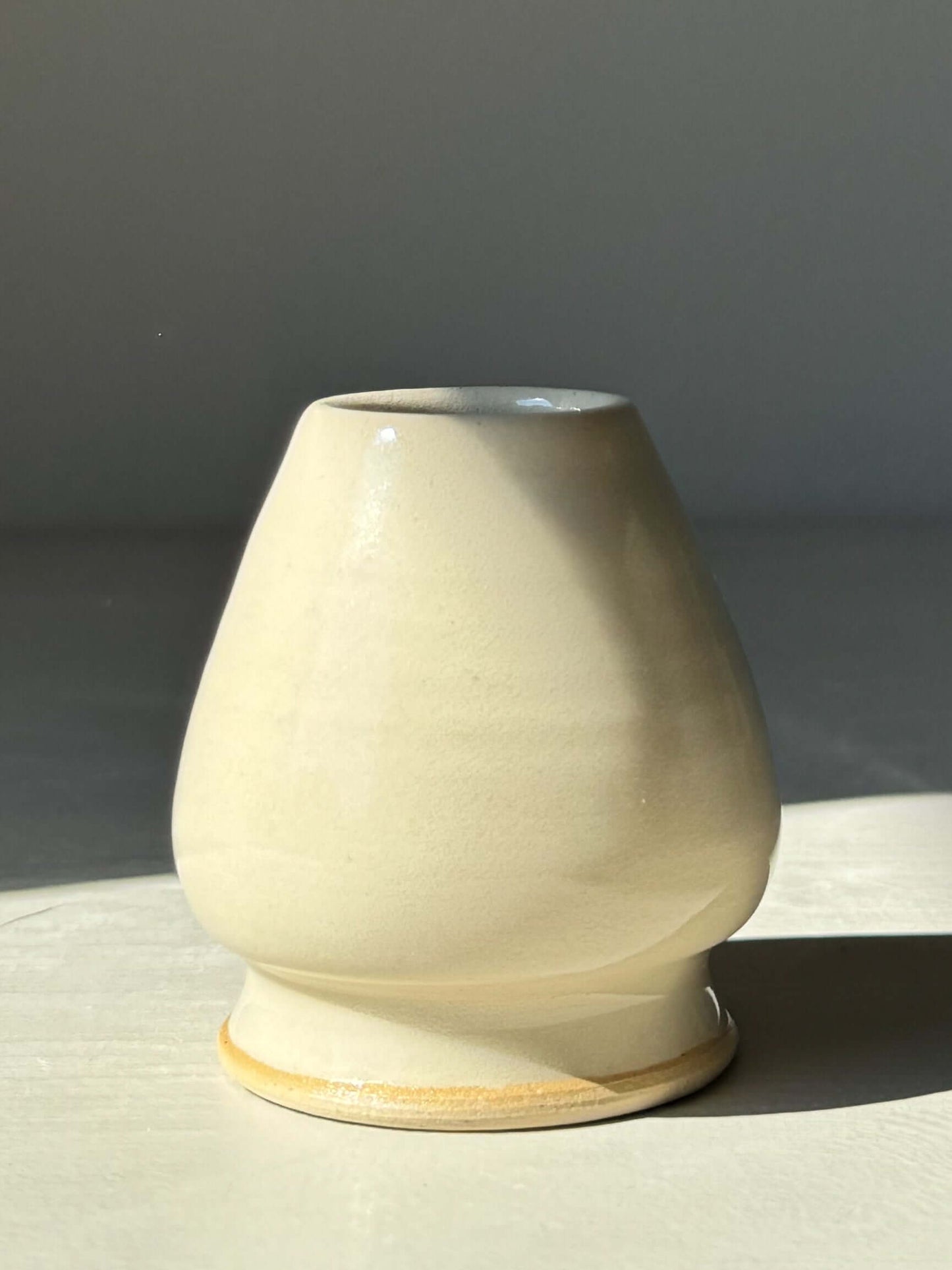 Clear glaze matcha whisk holder with elegant curves, designed to maintain chasen shape, showcasing natural stoneware beauty.