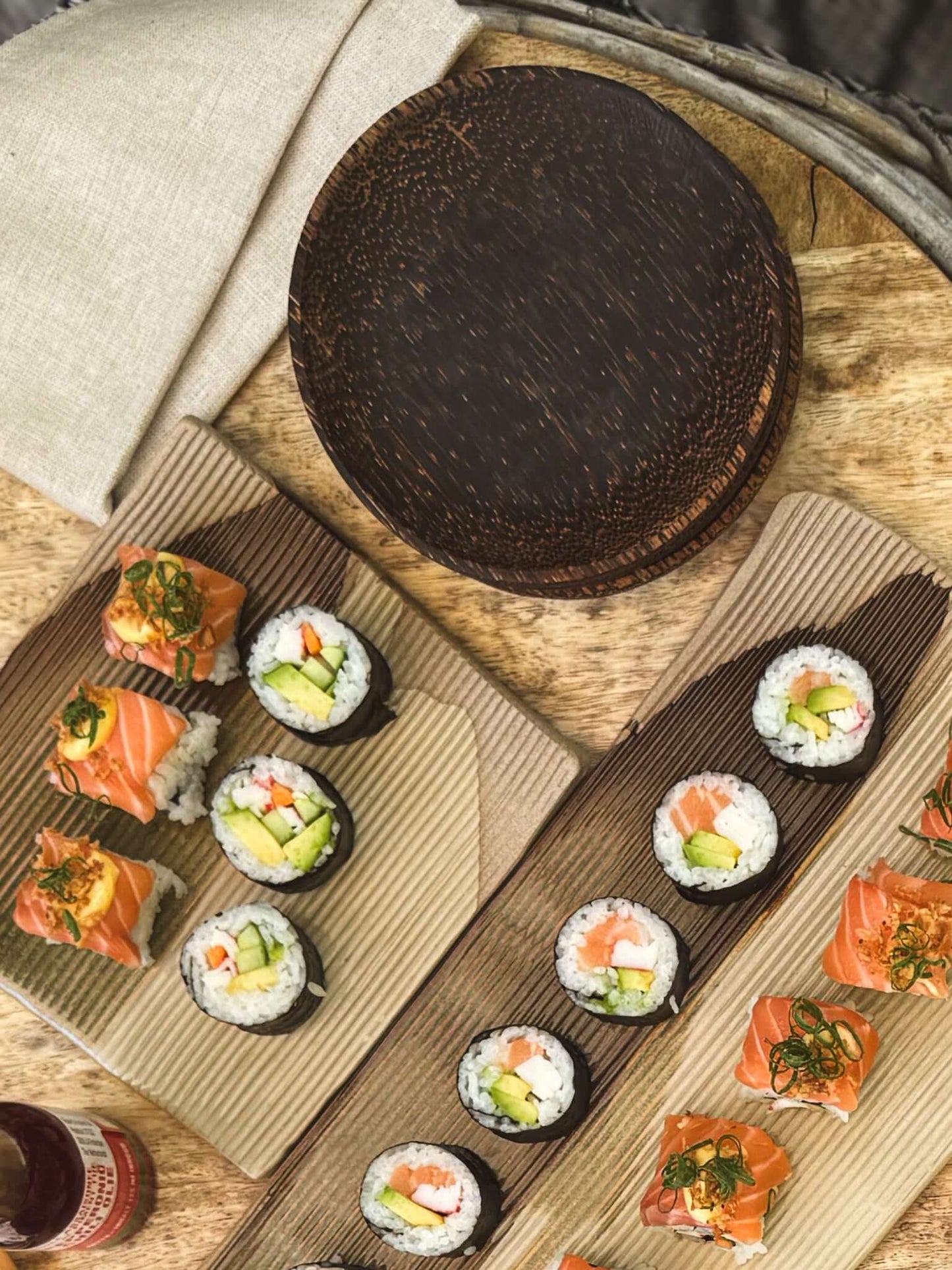 Coconut Wood Side Plates with sushi, handcrafted in Marrakech, showcasing unique grain patterns. Ideal for handmade ceramic and natural dining.