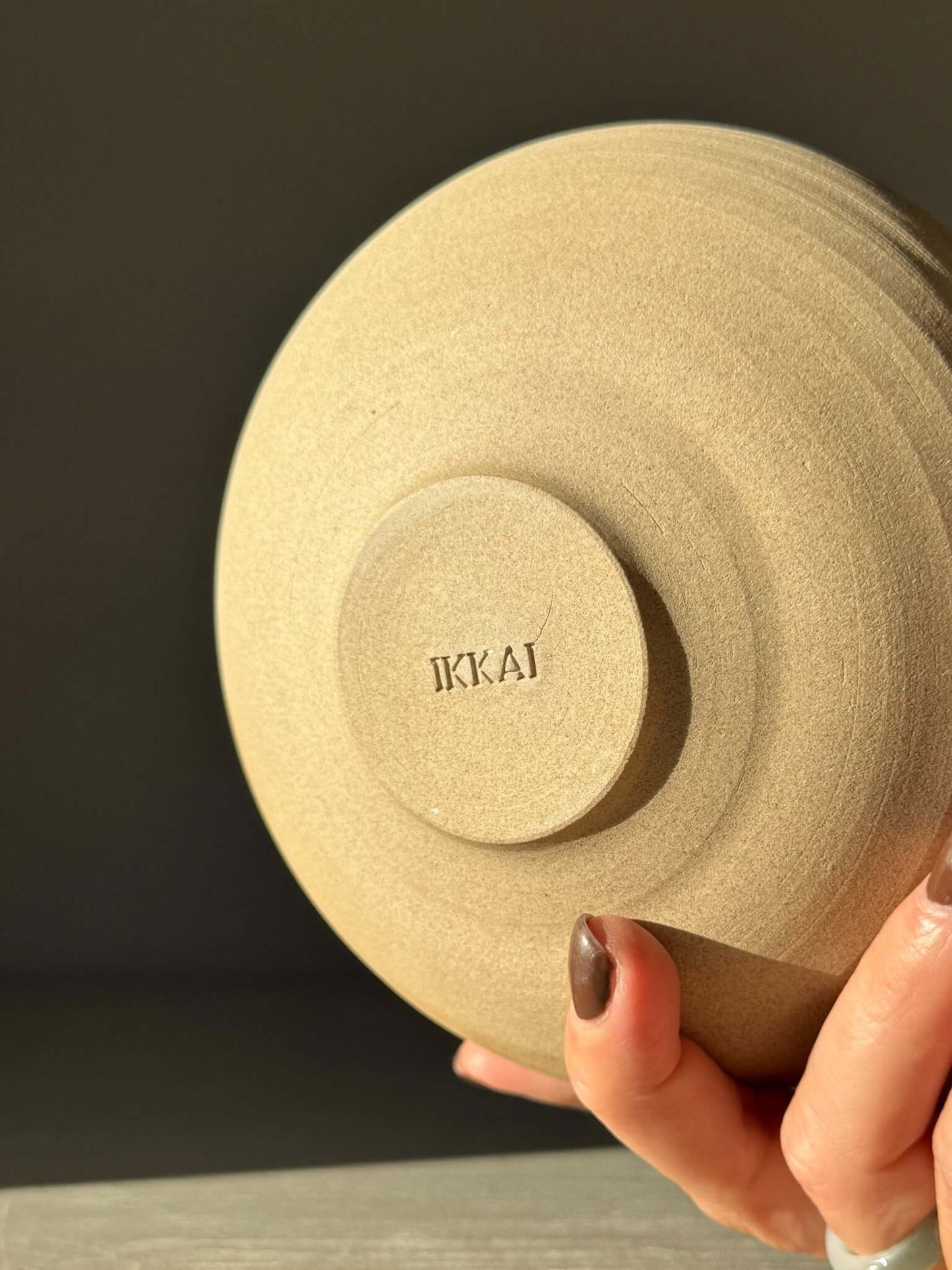 Hand holding Double-Walled Bowl - Inyo #02 with raw toffee-toned clay and textured surface.