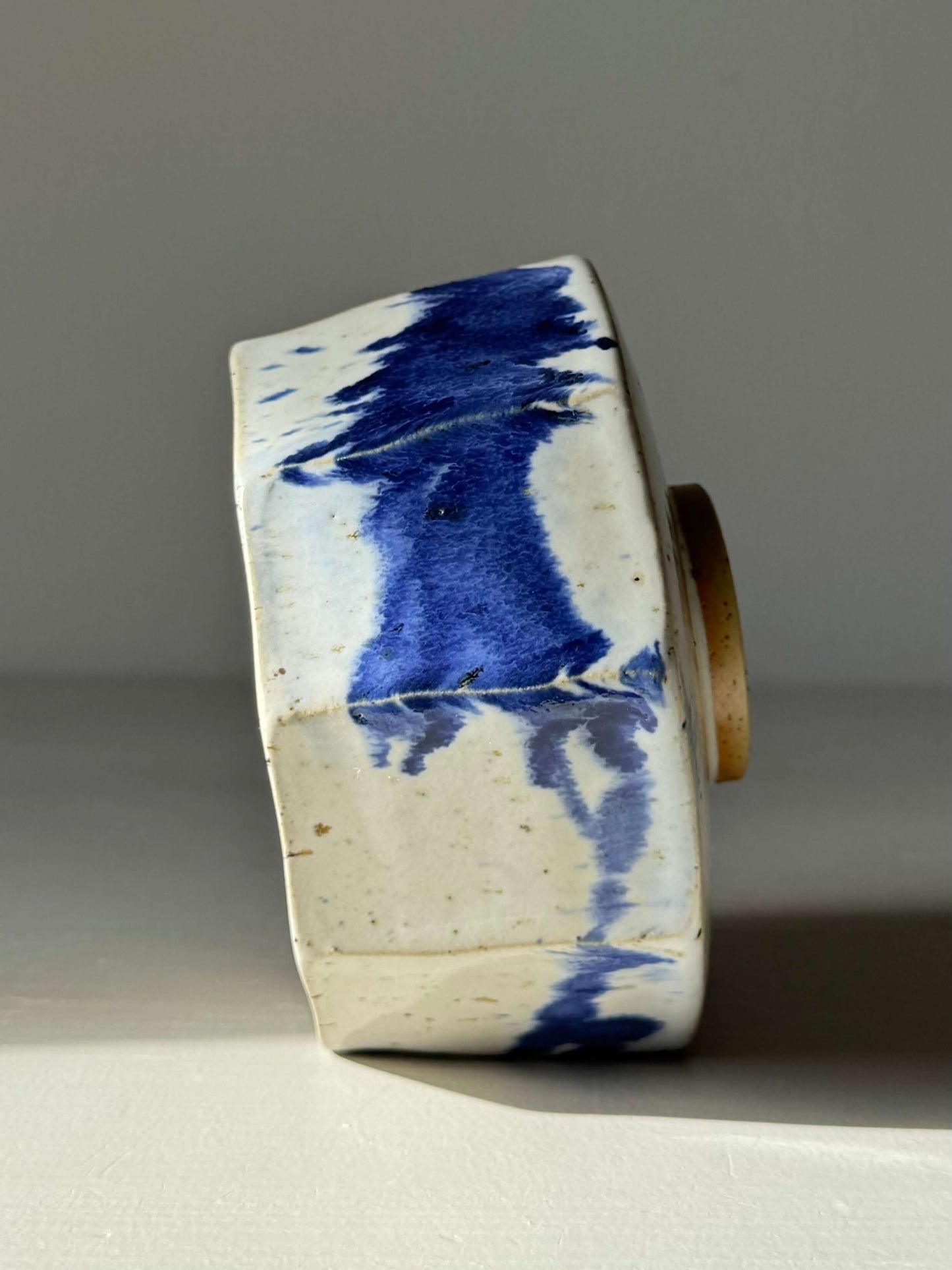 Side view of Faceted Matcha Bowl with Spout – Cobalt Blue & Glossy White Glaze #011, showcasing handmade ceramic design with blue accents.