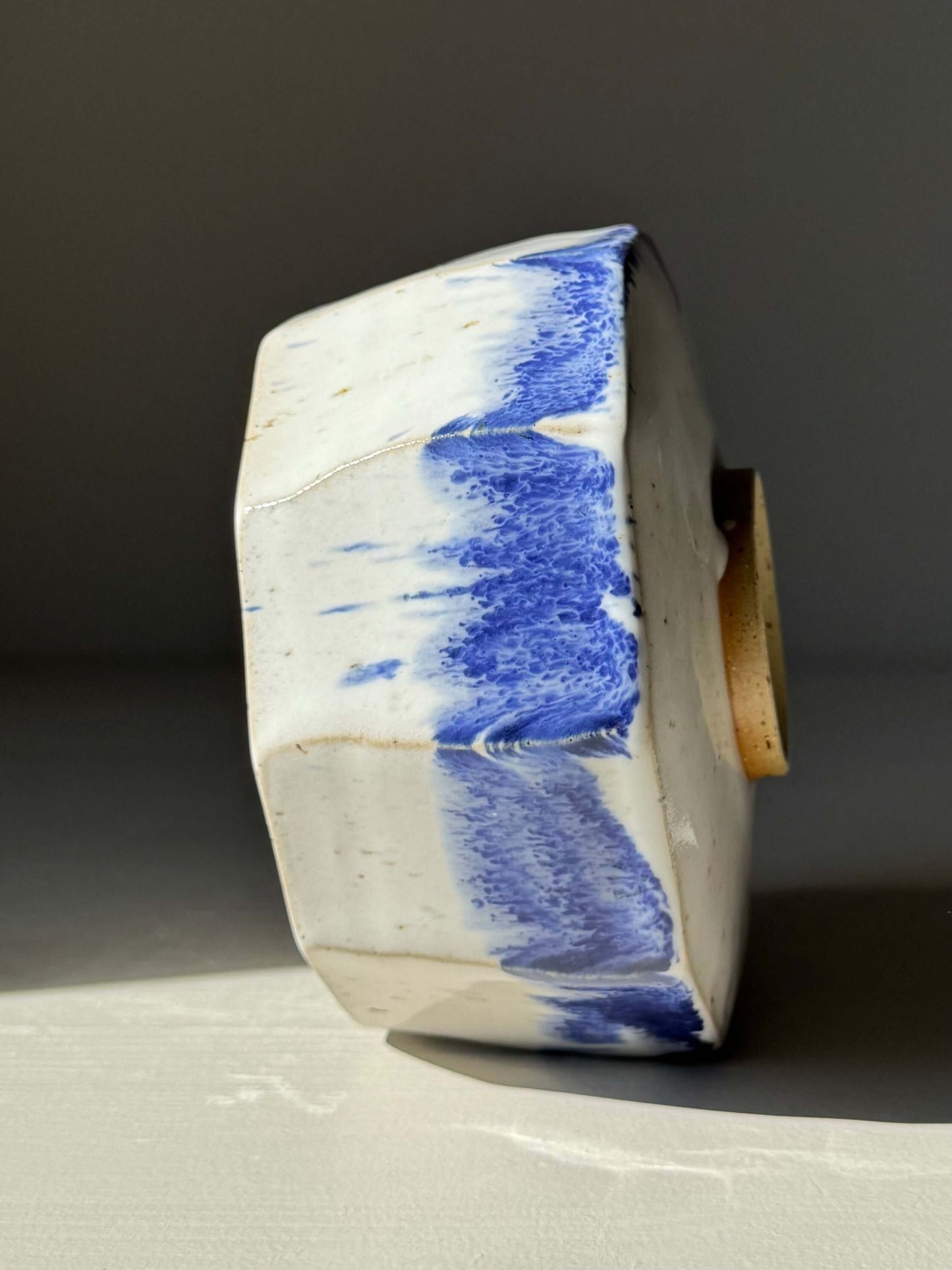 Side view of Faceted Matcha Bowl with Spout – Cobalt Blue & Glossy White Glaze #05, showcasing handmade ceramic design with blue accents.