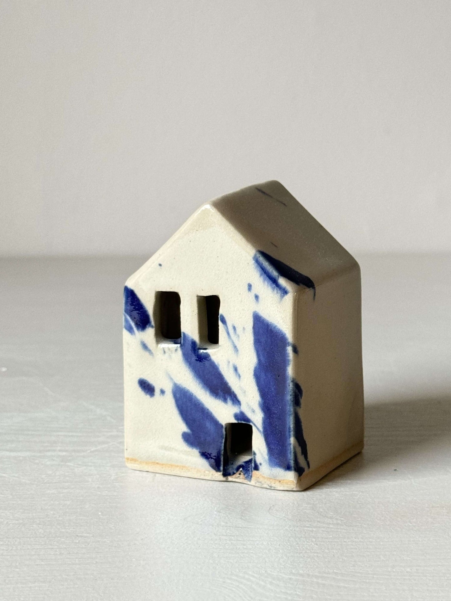 Handbuilt ceramic house with cobalt blue splashes, from the Gosu Series, adding a quirky, Dutch-inspired touch to decor.