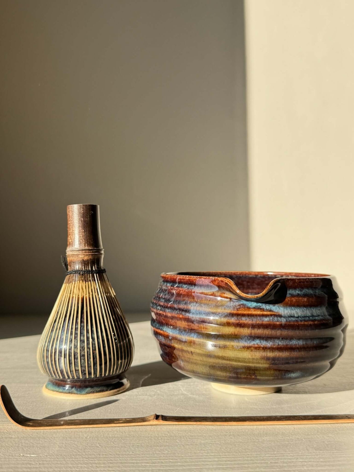 Ceramic Matcha Whisk Holder and bowl set in earthy tones with a bamboo scoop.