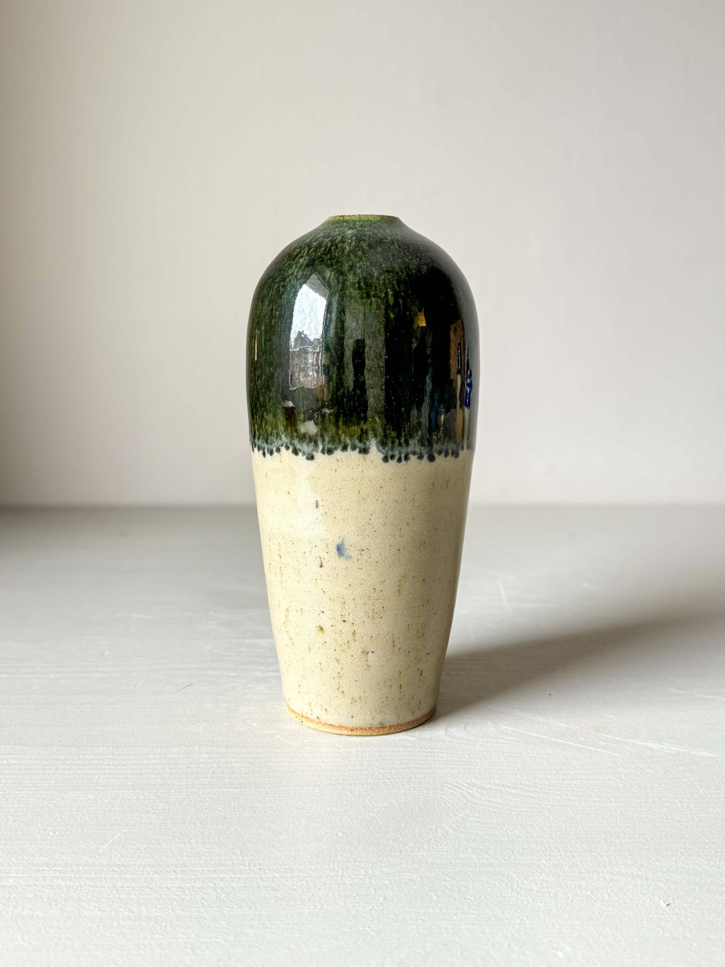 Handcrafted ceramic vase with glossy clear glaze and soft green rim, 18 cm tall. Perfect for adding a natural touch to home decor.