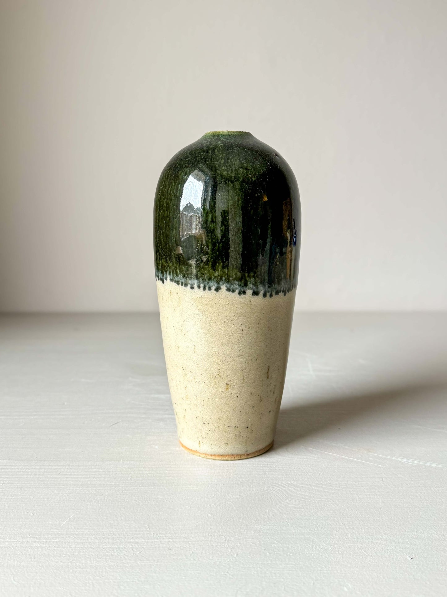 Handcrafted ceramic vase with glossy green rim and smooth design, 18 cm tall, perfect for adding a natural touch to home decor.