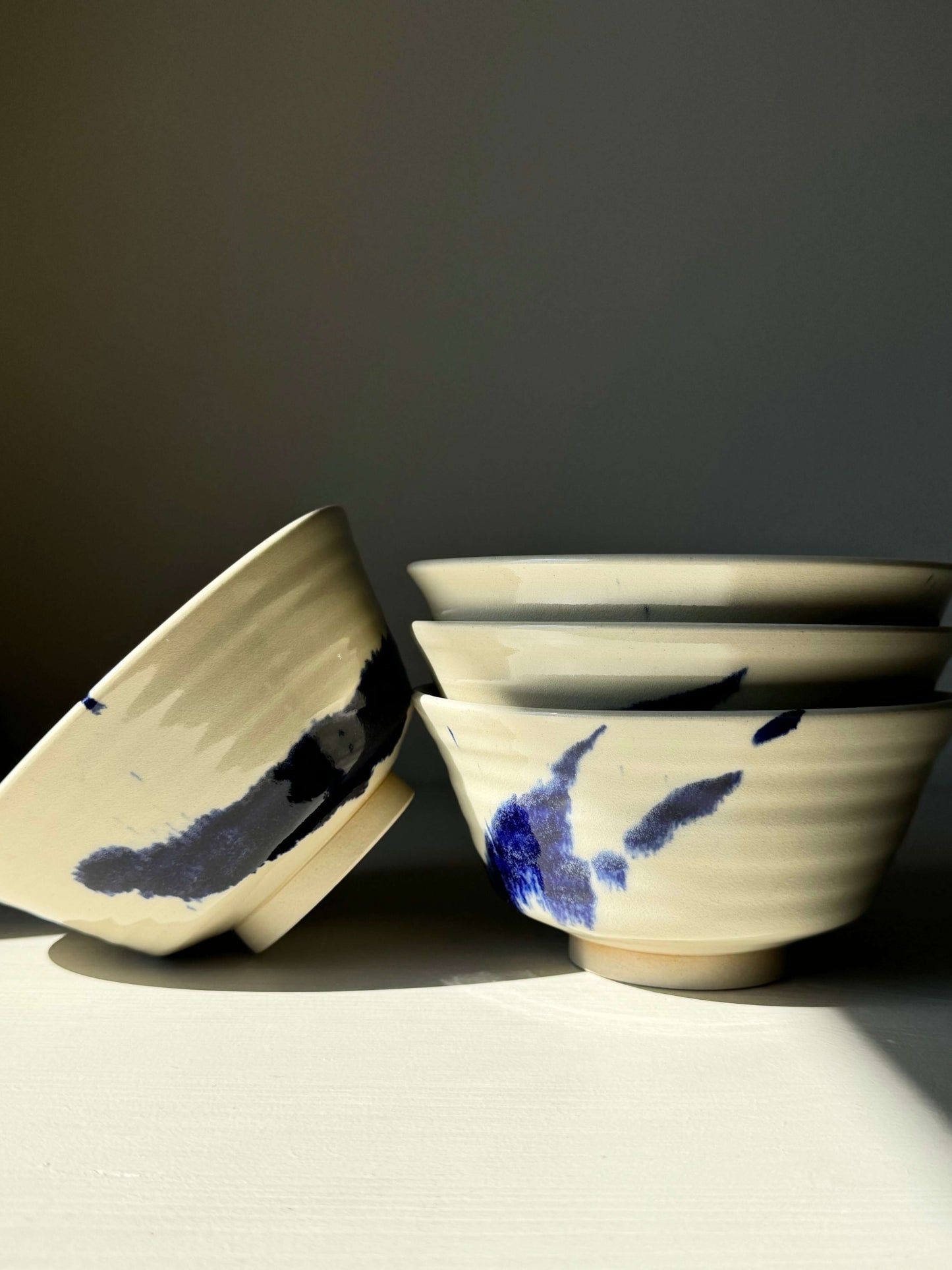 Handcrafted Gosu Series rice bowls with cobalt blue splashes, showcasing unique design and smooth clear glaze, ideal for rice and side dishes.