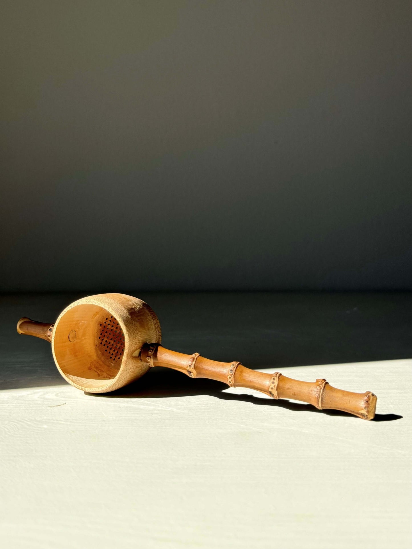 Handmade bamboo tea strainer with rustic design, perfect for straining loose leaf tea. Lightweight and durable kitchen accessory.