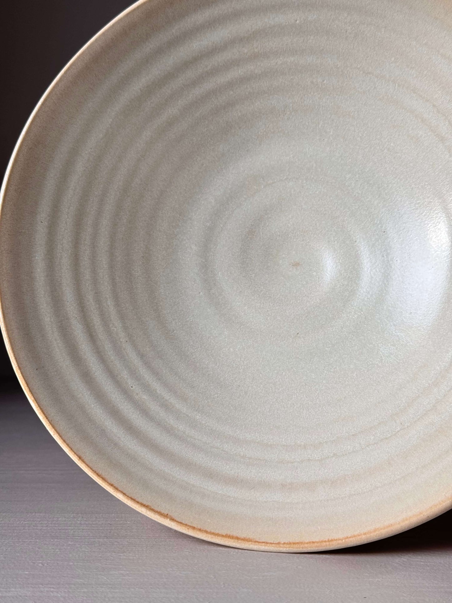 Handmade shallow dish with Moonstone glaze, 22cm diameter, 6cm height, wheel-thrown from stoneware clay, showcasing a unique texture.