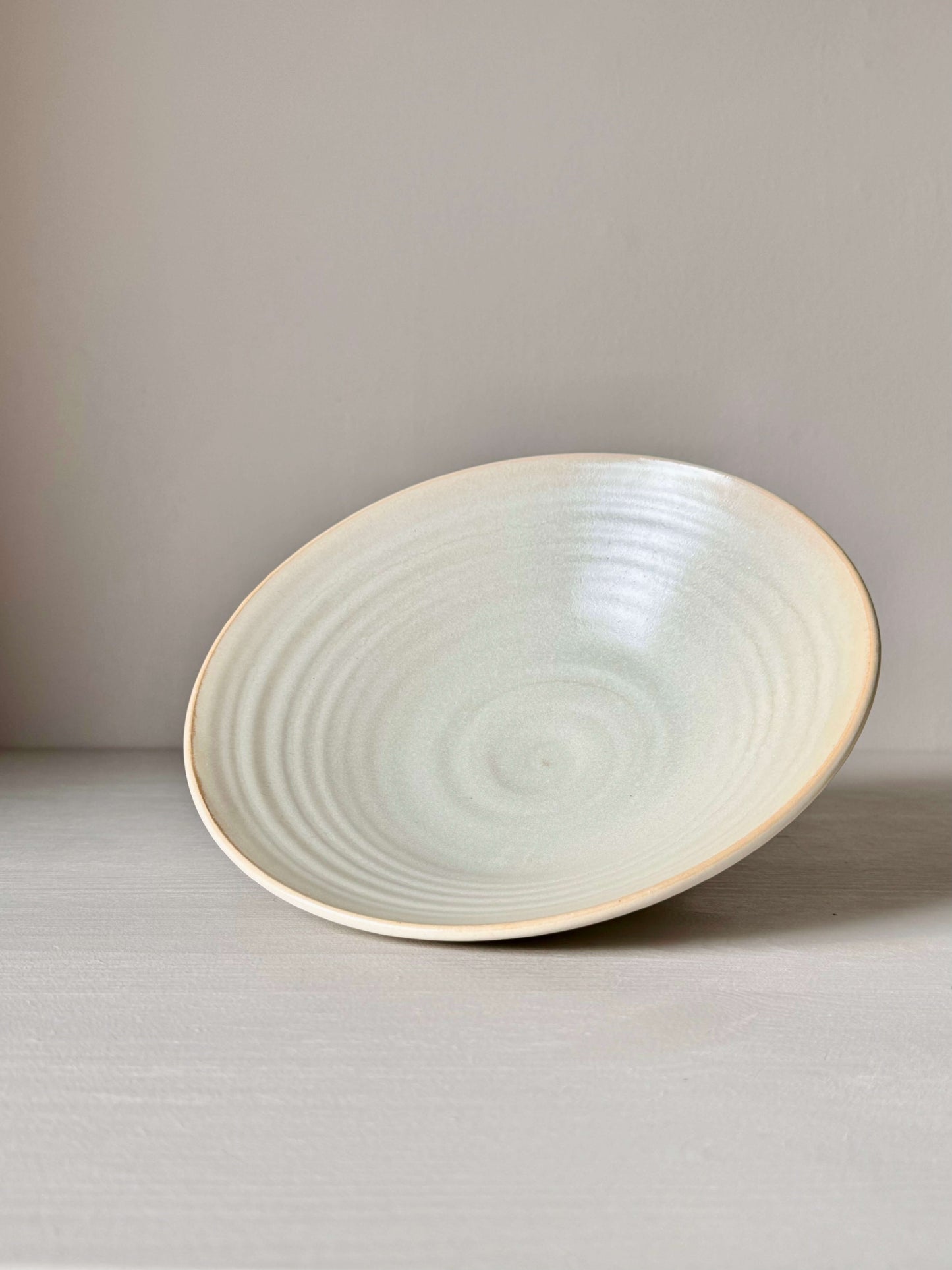 Handmade Moonstone glazed shallow dish, wheel-thrown stoneware, 6cm high, 22cm diameter, food-safe, lead-free. Unique ceramic design.