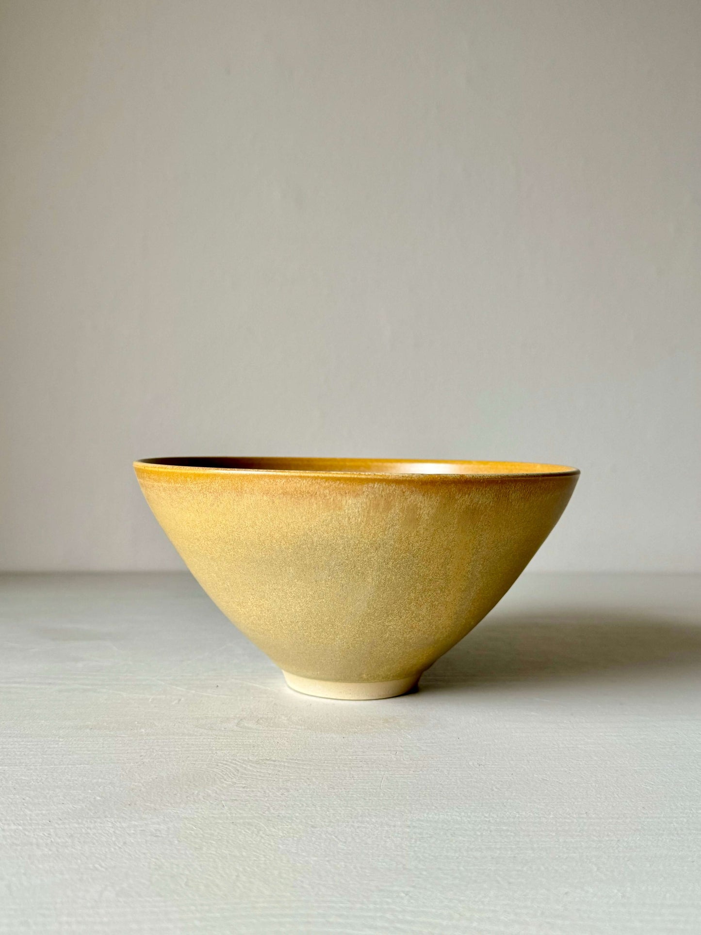 Handmade medium pottery bowl with yellow glaze, made of stoneware clay, perfect for breakfast, soups, or desserts; 9cm height, 18cm diameter.