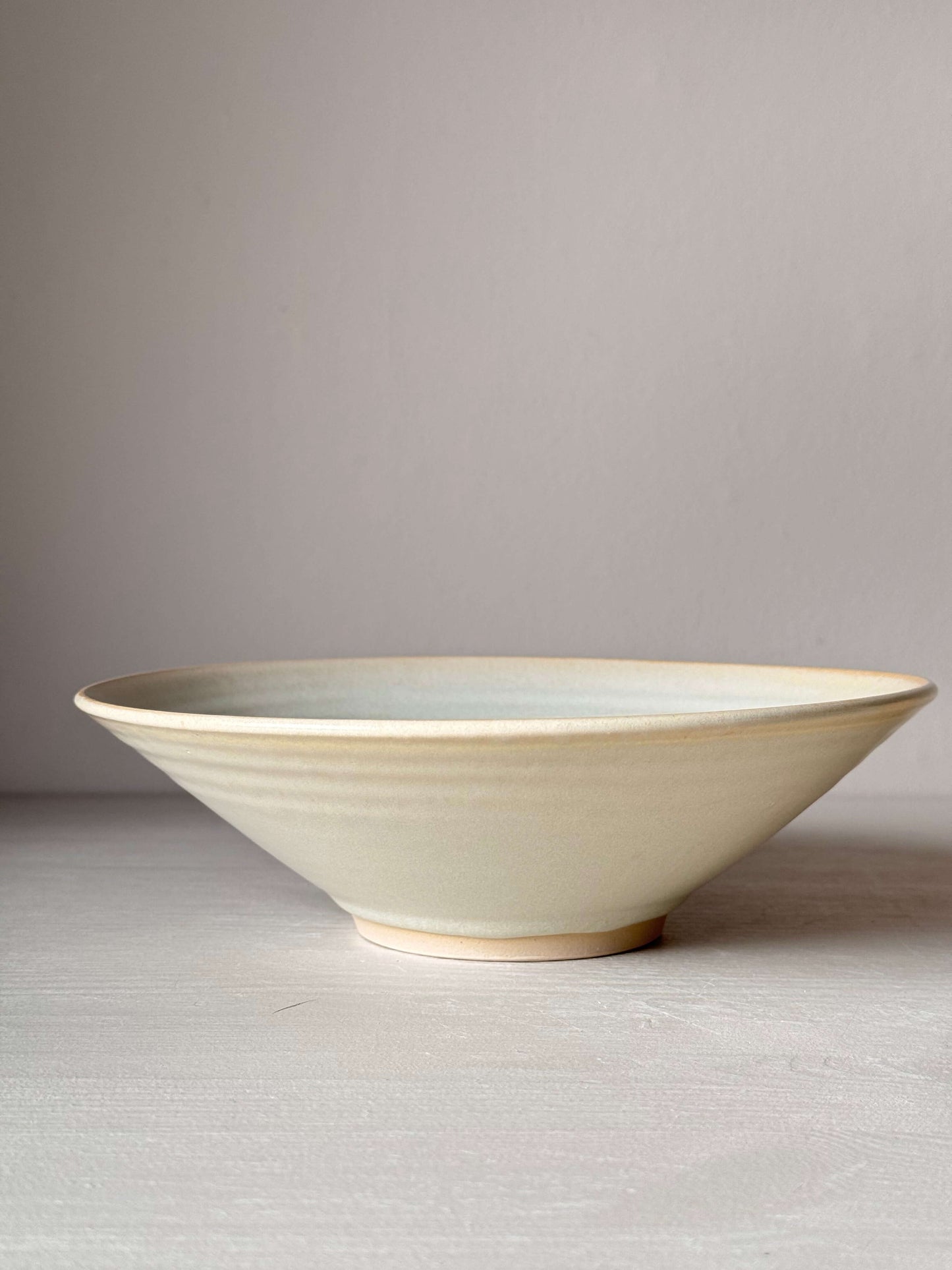 Handmade wheel-thrown stoneware shallow dish with Moonstone glaze, 6cm height, 22cm diameter, food-safe, unique design.