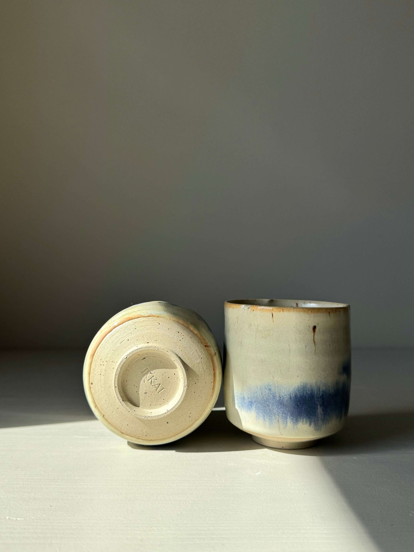 Cobalt Blue & Moonstone Glaze Yunomi Cups, showcasing subtle flower-shaped rims and handcrafted design.