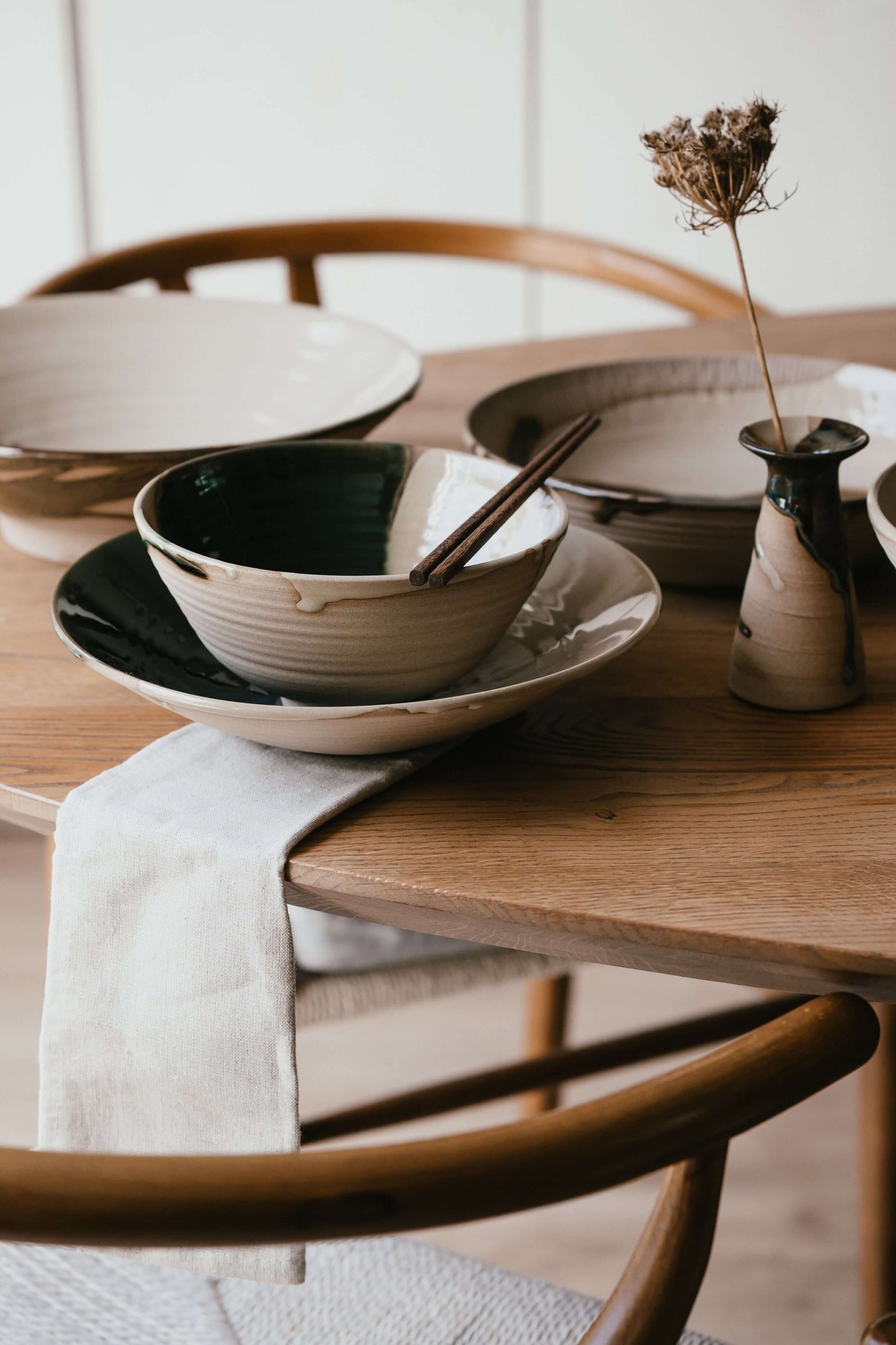 Wooden Chopsticks Set with handmade ceramic bowl on wooden dining table.