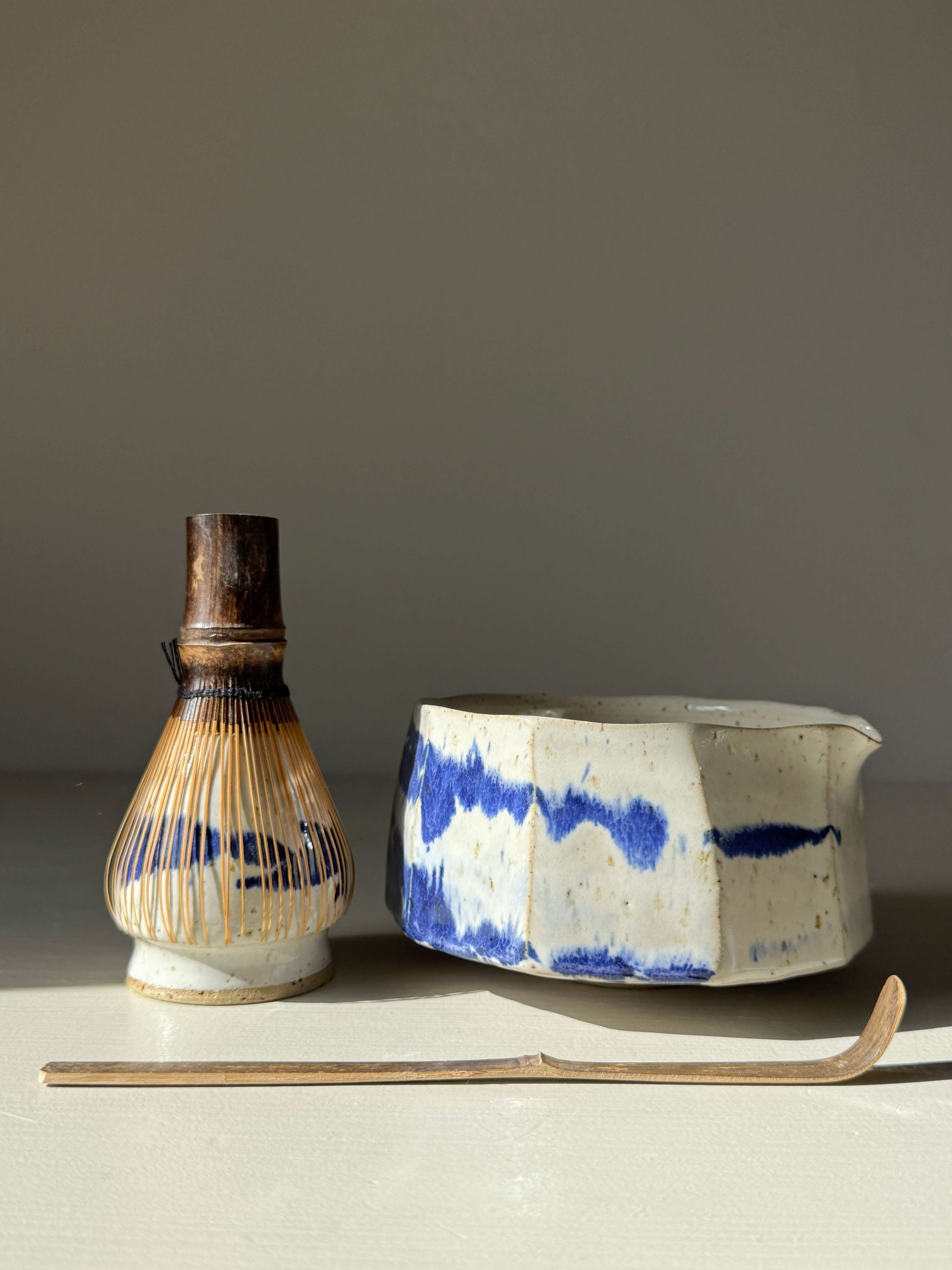 Handmade ceramic Faceted Matcha Bowl with Spout – Cobalt Blue & Glossy White Glaze #010 with traditional whisk and spoon.