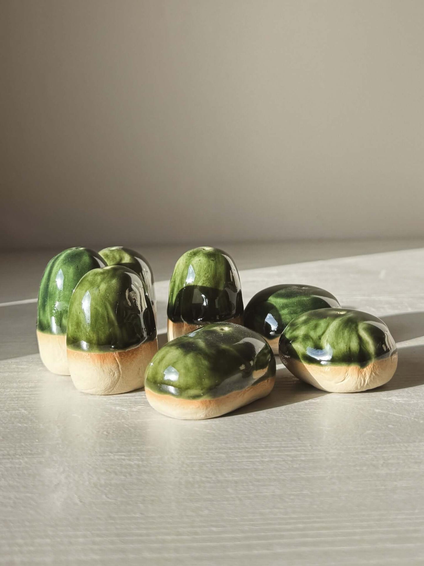Glazed stoneware Incense Holder Pebbles resembling smooth river stones in soft natural tones on a light surface.