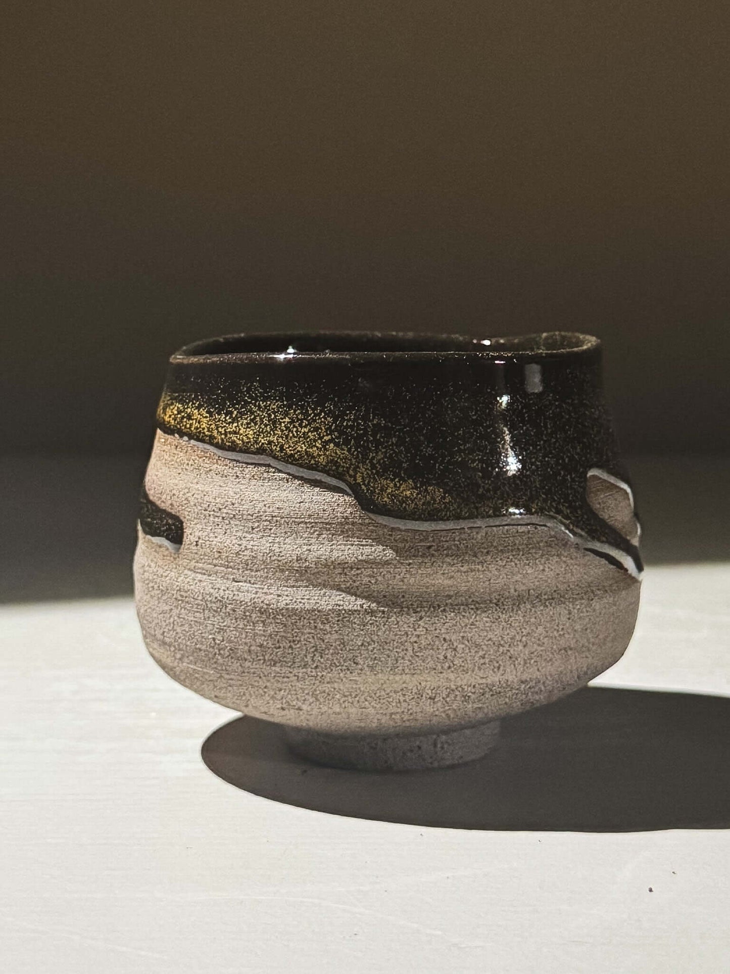 Yunomi Cup - Kuro Ash #01 featuring a glossy black glaze and subtle golden speckles.