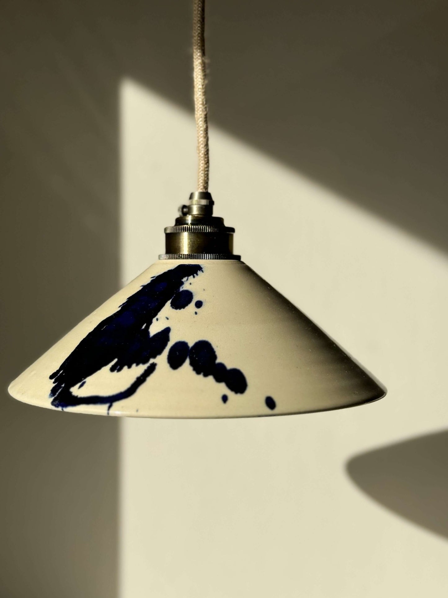 Handmade ceramic lamp shade from the Gosu Series with cobalt blue splashes, highlighting its unique, artistic design.