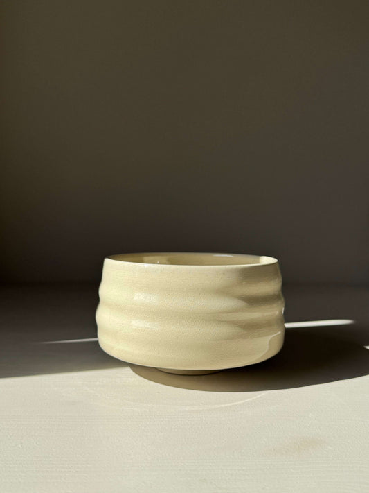 Handmade ceramic Matcha Bowl - Clear Glaze #03 with natural ridges, showcasing warm clay tone and unique glow under sunlight.