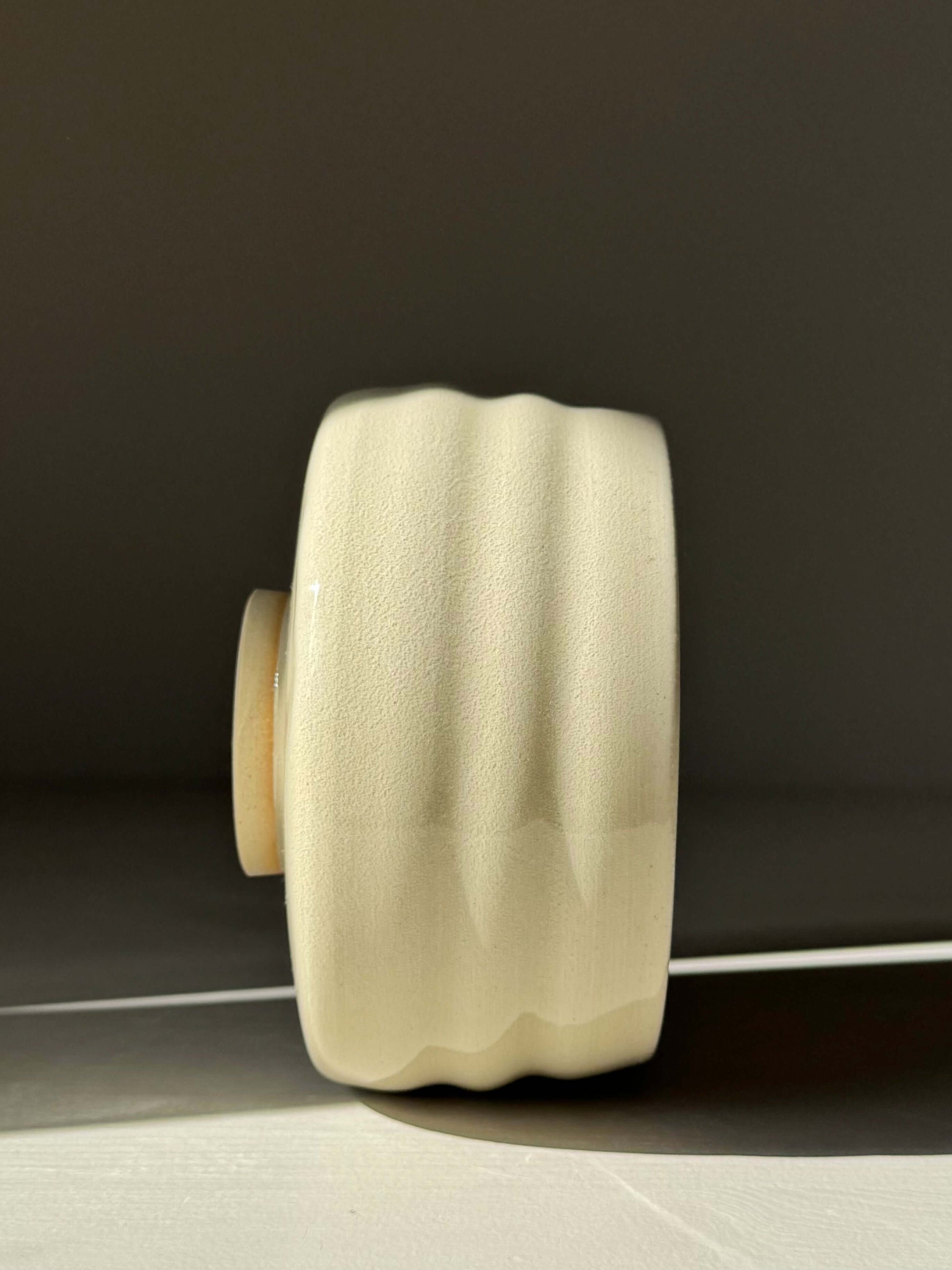 Side view of Matcha Bowl - Clear Glaze #03, a handmade ceramic with flowing ridges and clear glaze over natural stoneware.