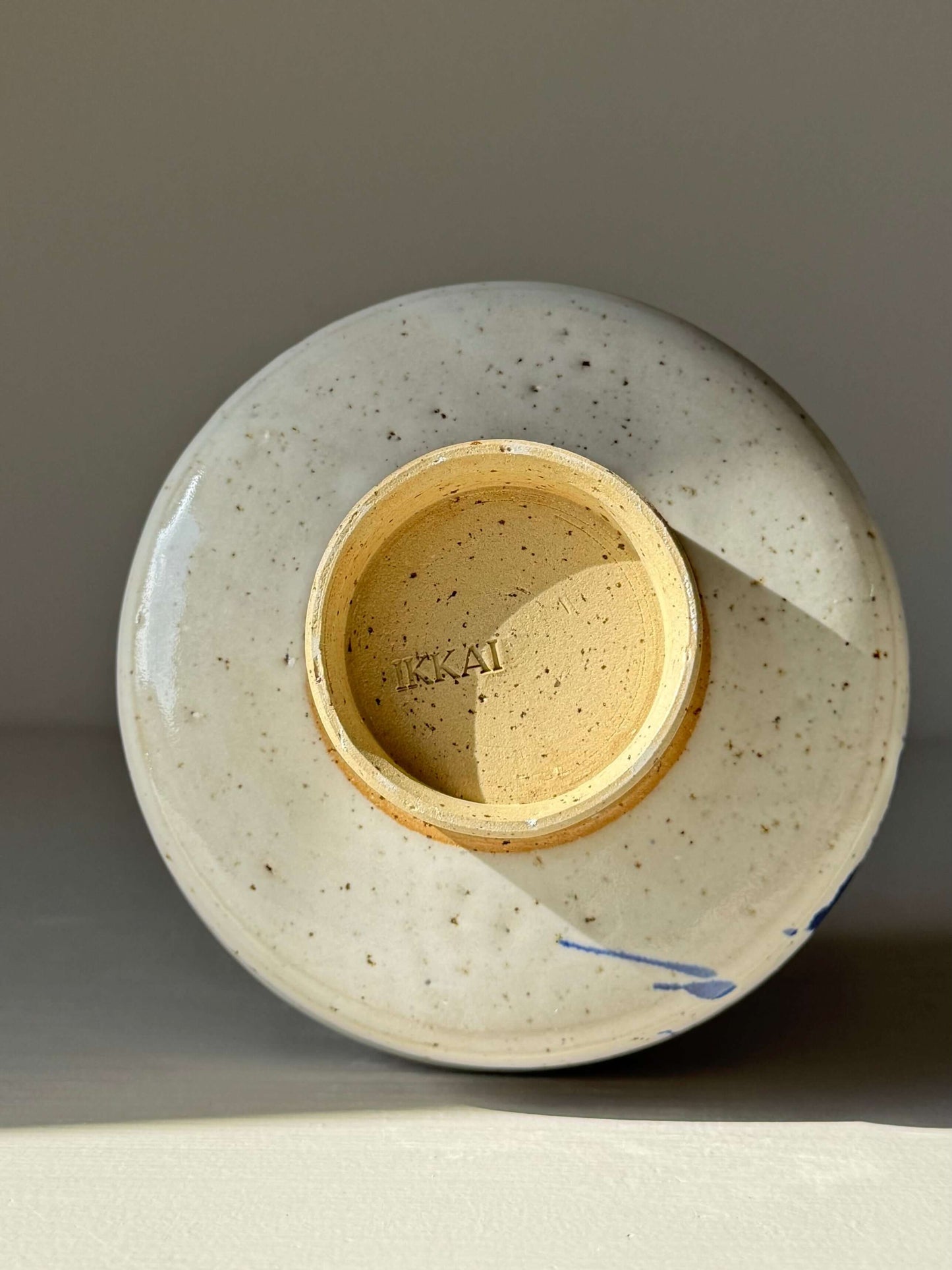 Bottom view of Matcha Bowl – Cobalt Blue & Glossy White #01 handmade ceramic with cobalt splash pattern.