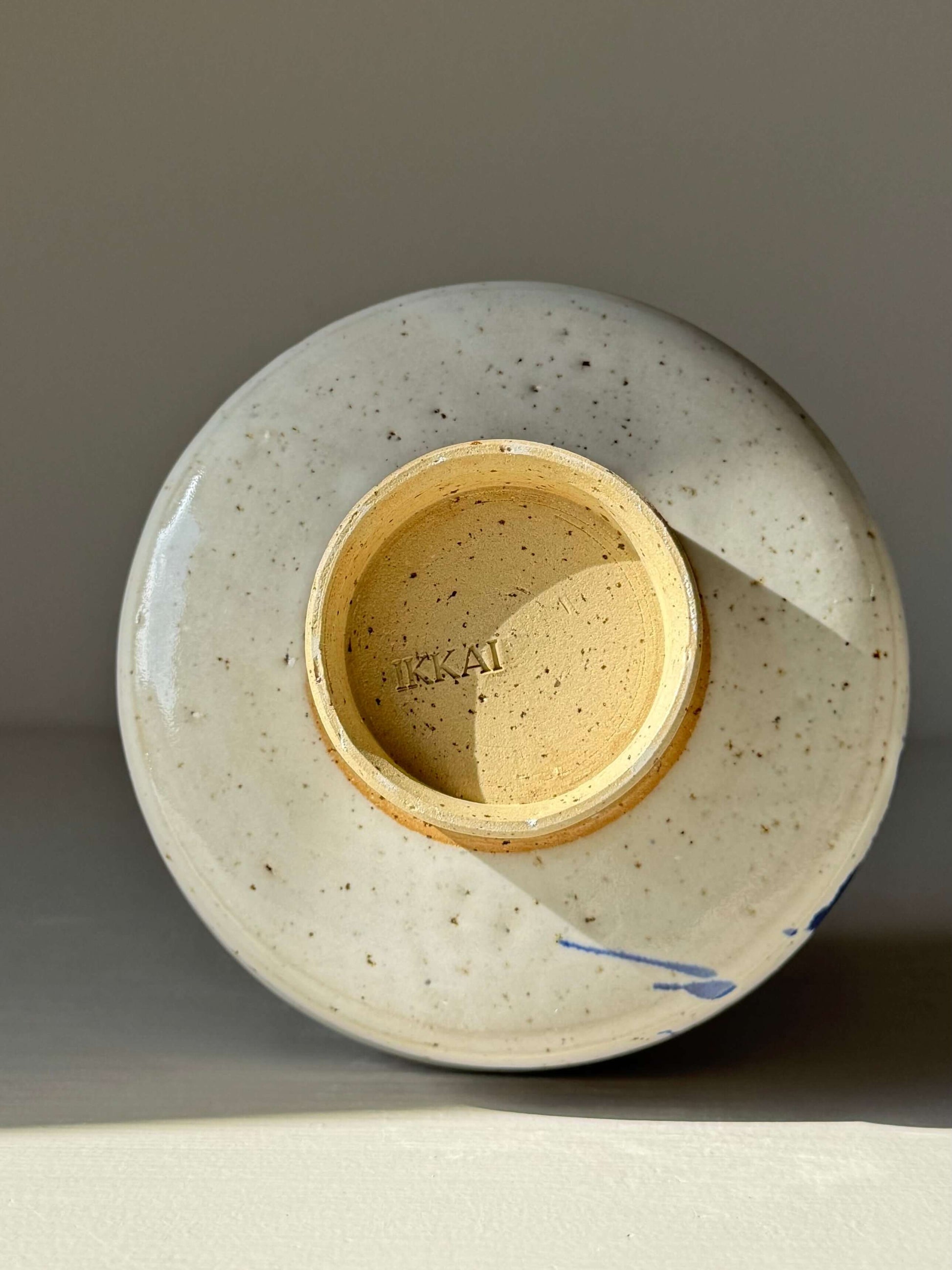 Bottom view of Matcha Bowl – Cobalt Blue & Glossy White #01 handmade ceramic with cobalt splash pattern.
