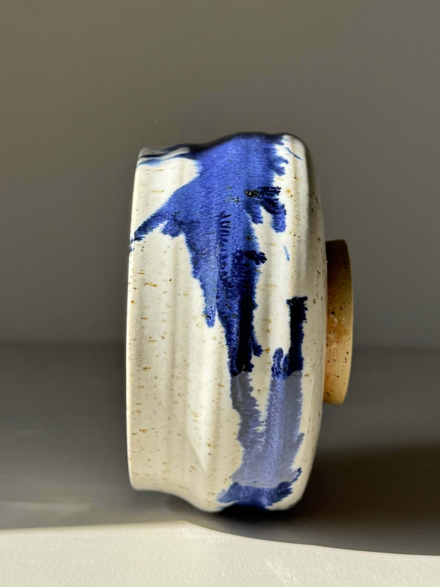 Handmade ceramic Matcha Bowl – Cobalt Blue & Glossy White #02, featuring a rounded form with flowing ridges and unique splash pattern.