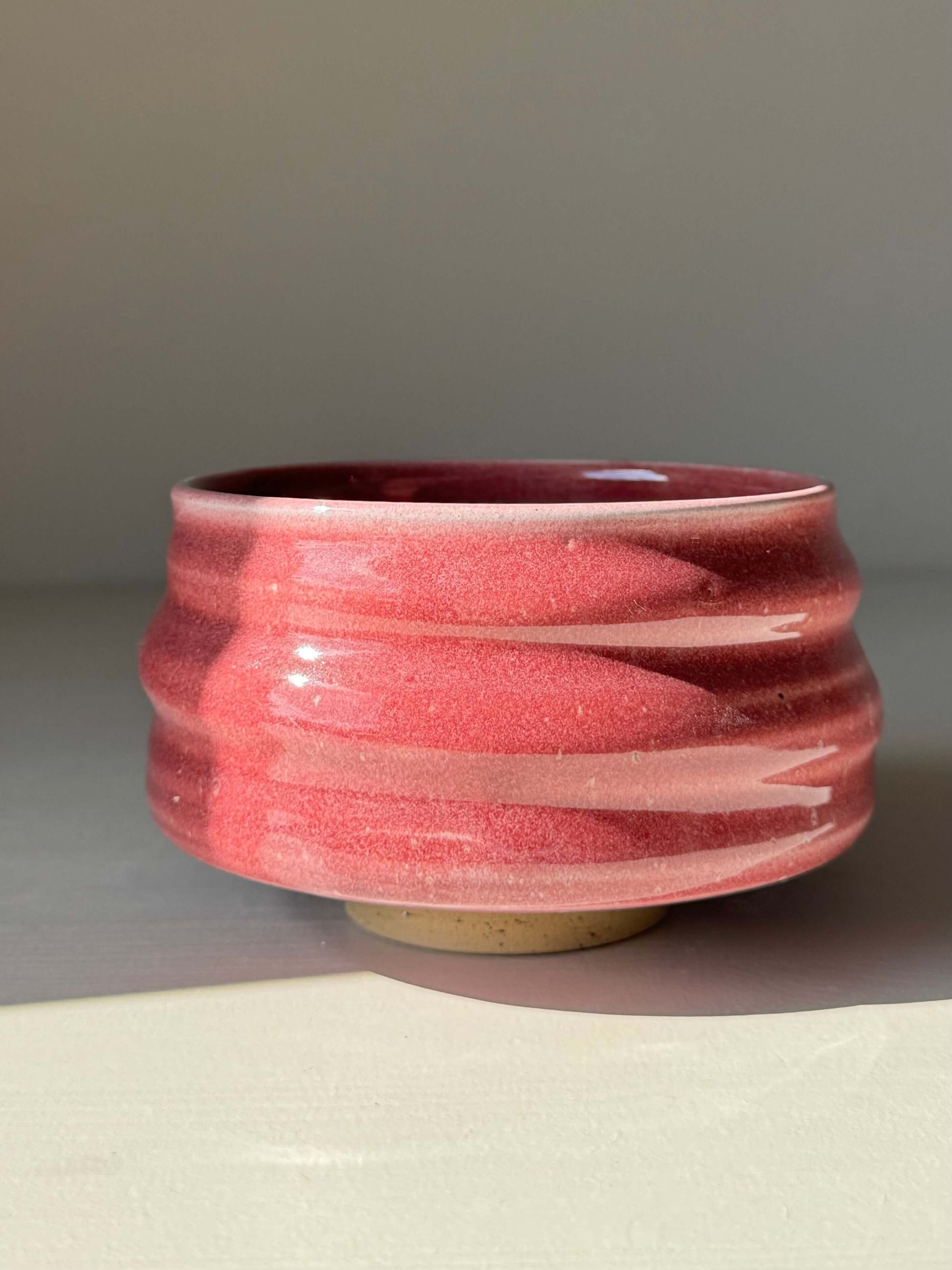 Alt Tag: Handmade ceramic Matcha Bowl - Ume Series #06 in pink inspired by Japanese Ume blossom with flowing ridges.