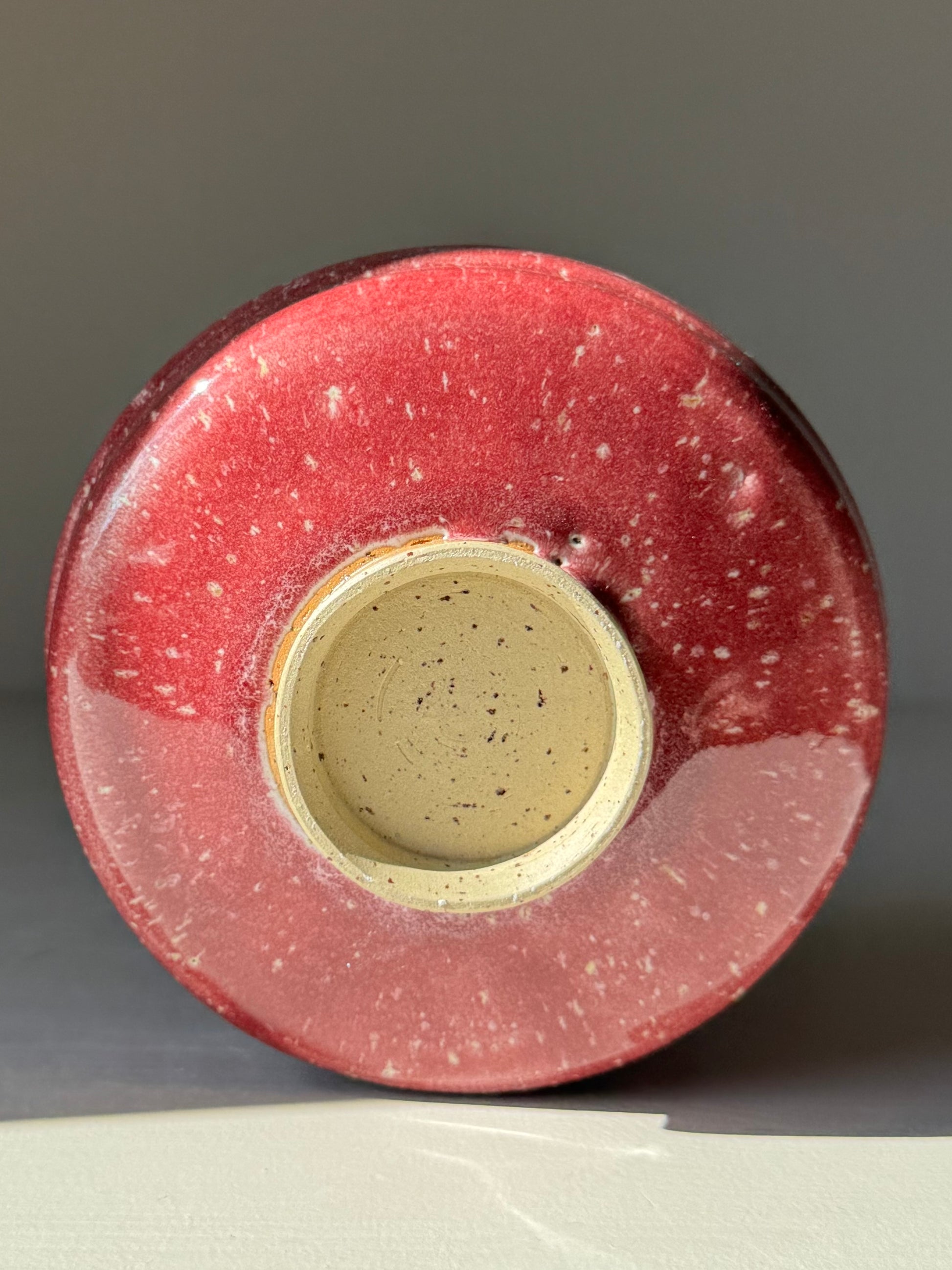 Base of Matcha Bowl - Ume Series #08 handmade ceramic with red speckled glaze, showcasing sculptural design.