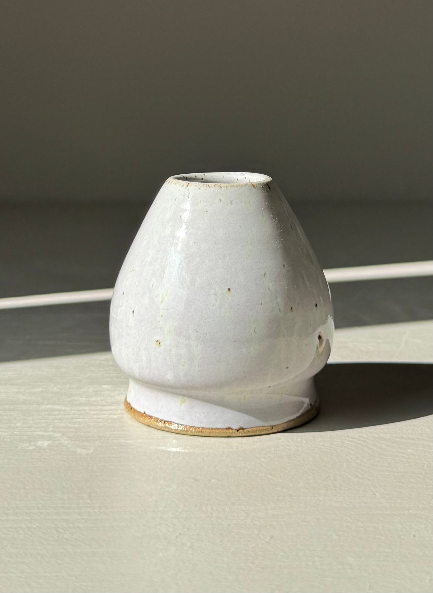 Matcha Whisk Holder - Pale Lilac handmade ceramic with cloud-like glaze, showcasing its unique texture and softness in natural light.