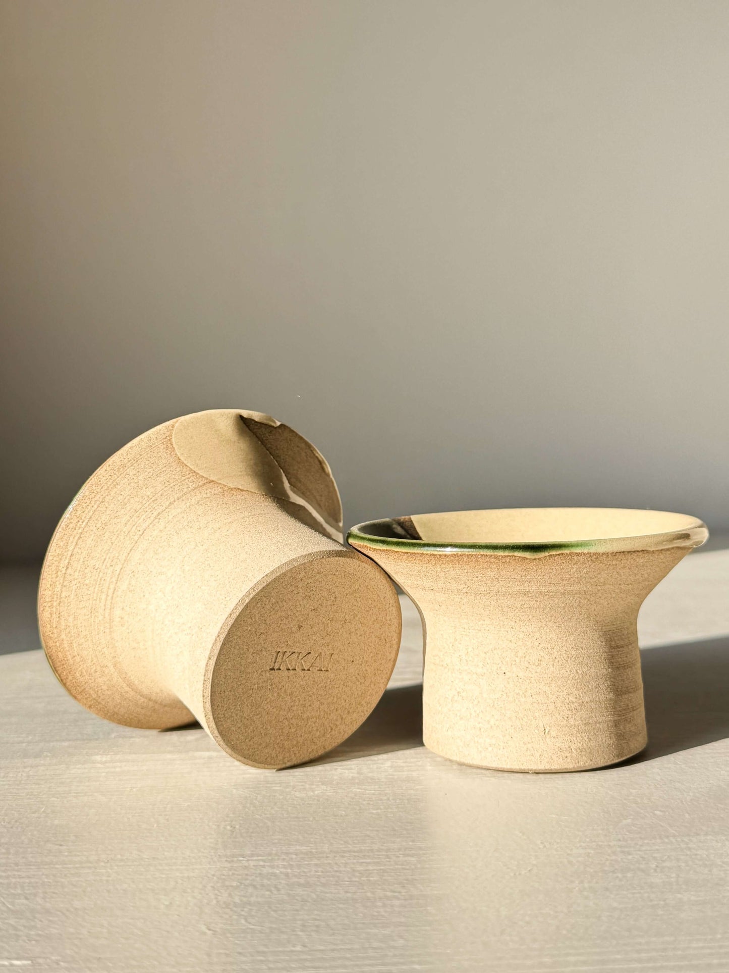 Handmade ceramic Egg Cup - Mori with soft green Mori glaze on stoneware, showcasing flared design and glossy finish.