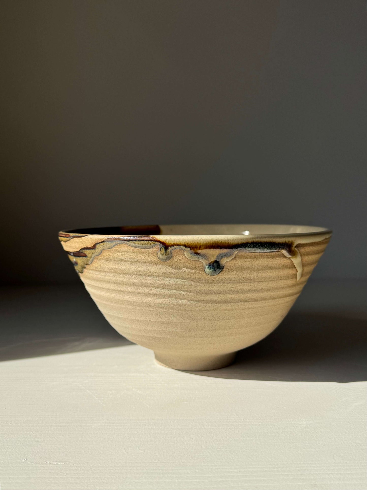 Handmade ceramic Ramen Bowl - Inyo Series featuring glossy tenmoku and clear glaze on a toffee clay surface.