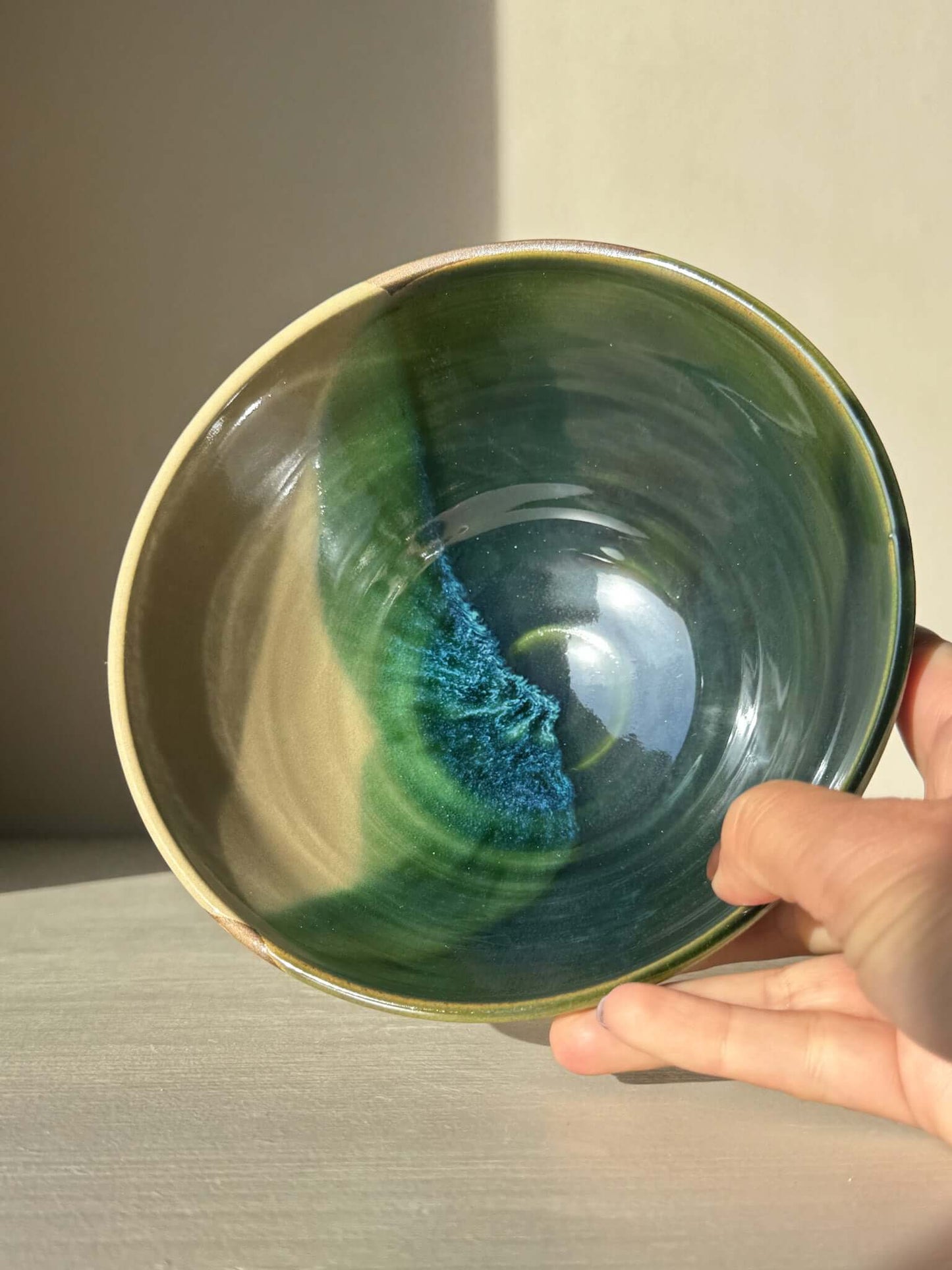 Hand holding a Soup Bowl – Mori Series with unique green glaze inside, showcasing handcrafted stoneware design.