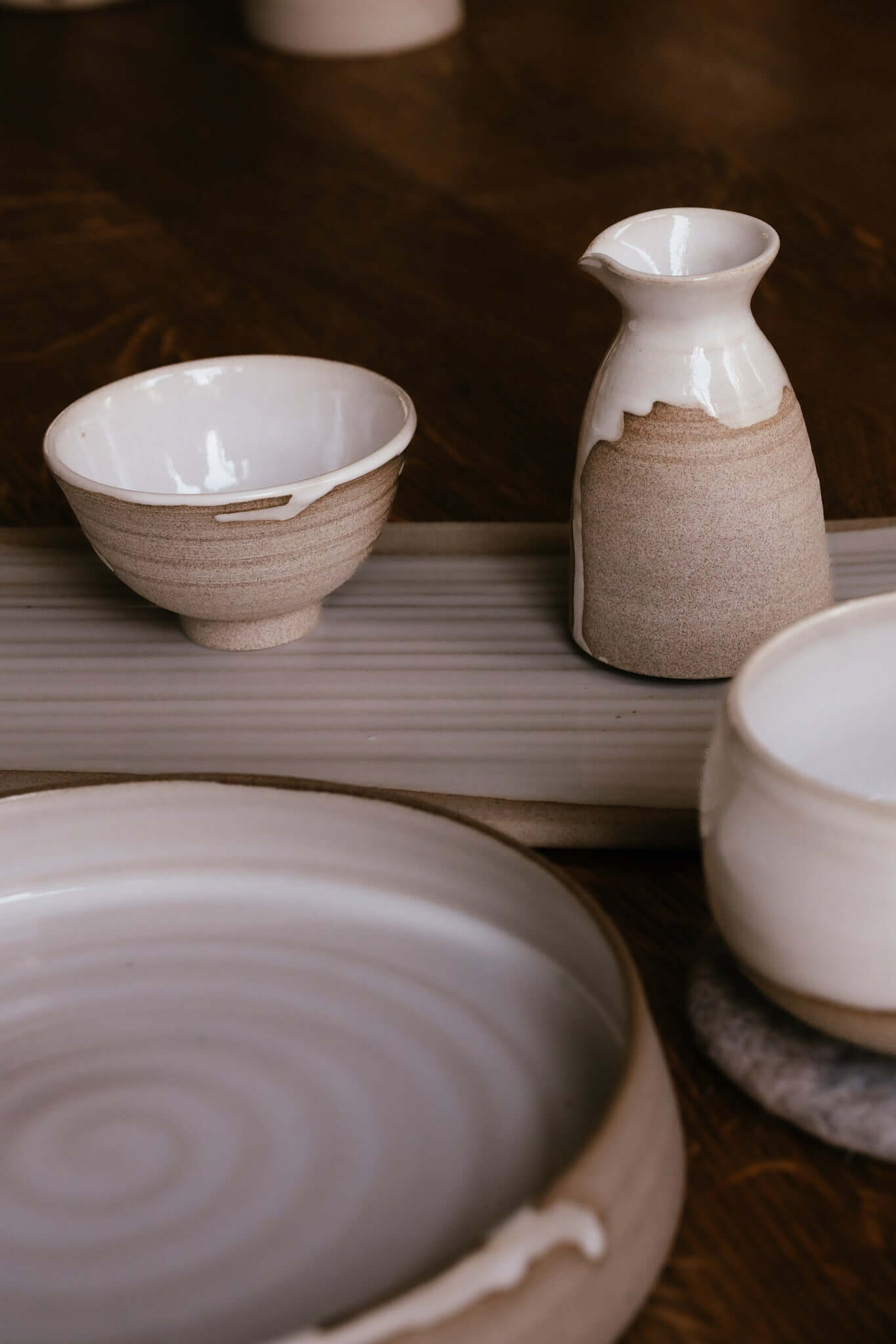 Soya Pourer - Yuki on a table with elegant ceramic dishware.