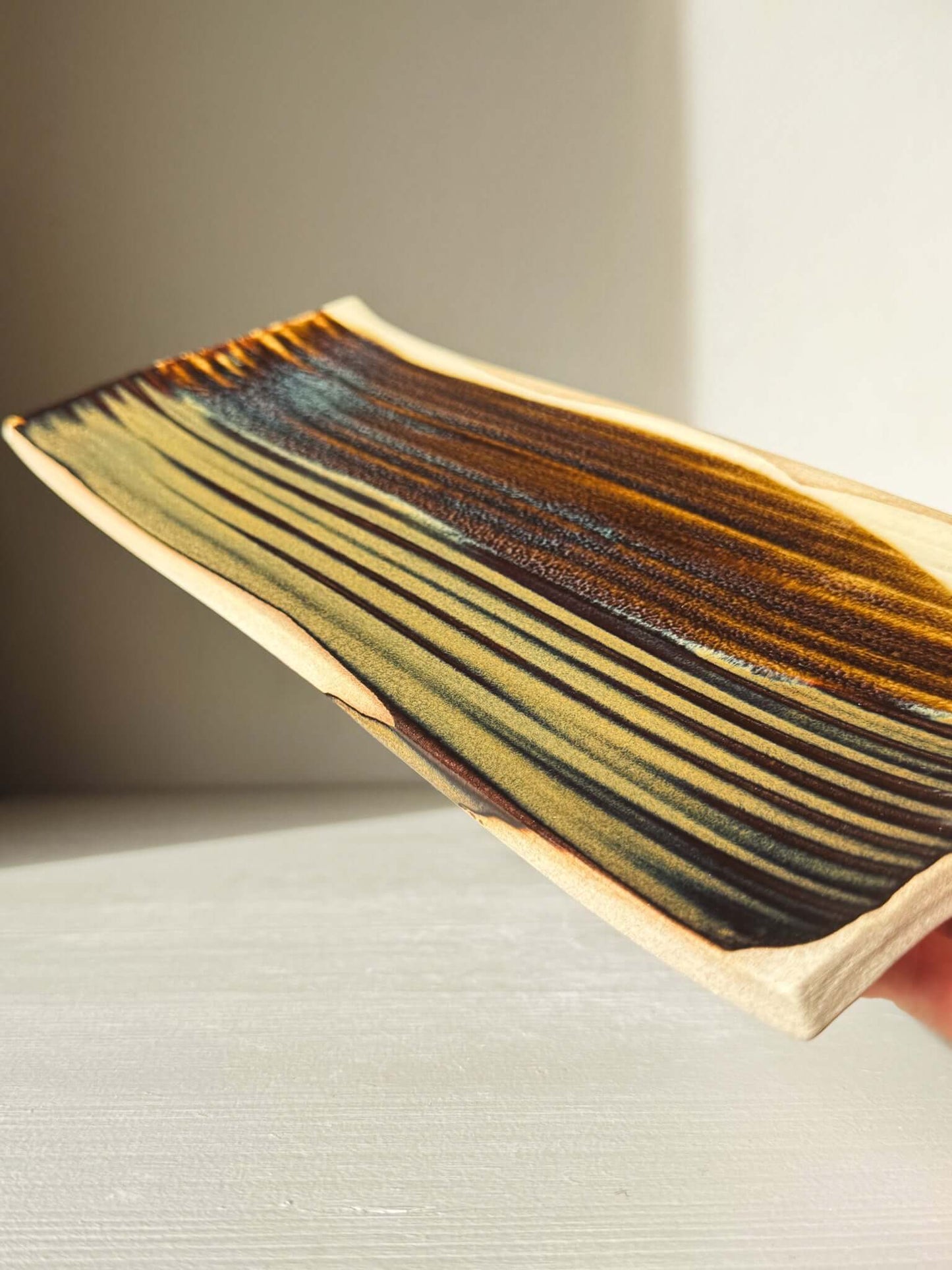 Sushi Plate – Inyo #02 with unique tenmoku glazing and soft curves, crafted from a wheel-thrown cylinder, size approx. 33cm x 13cm.