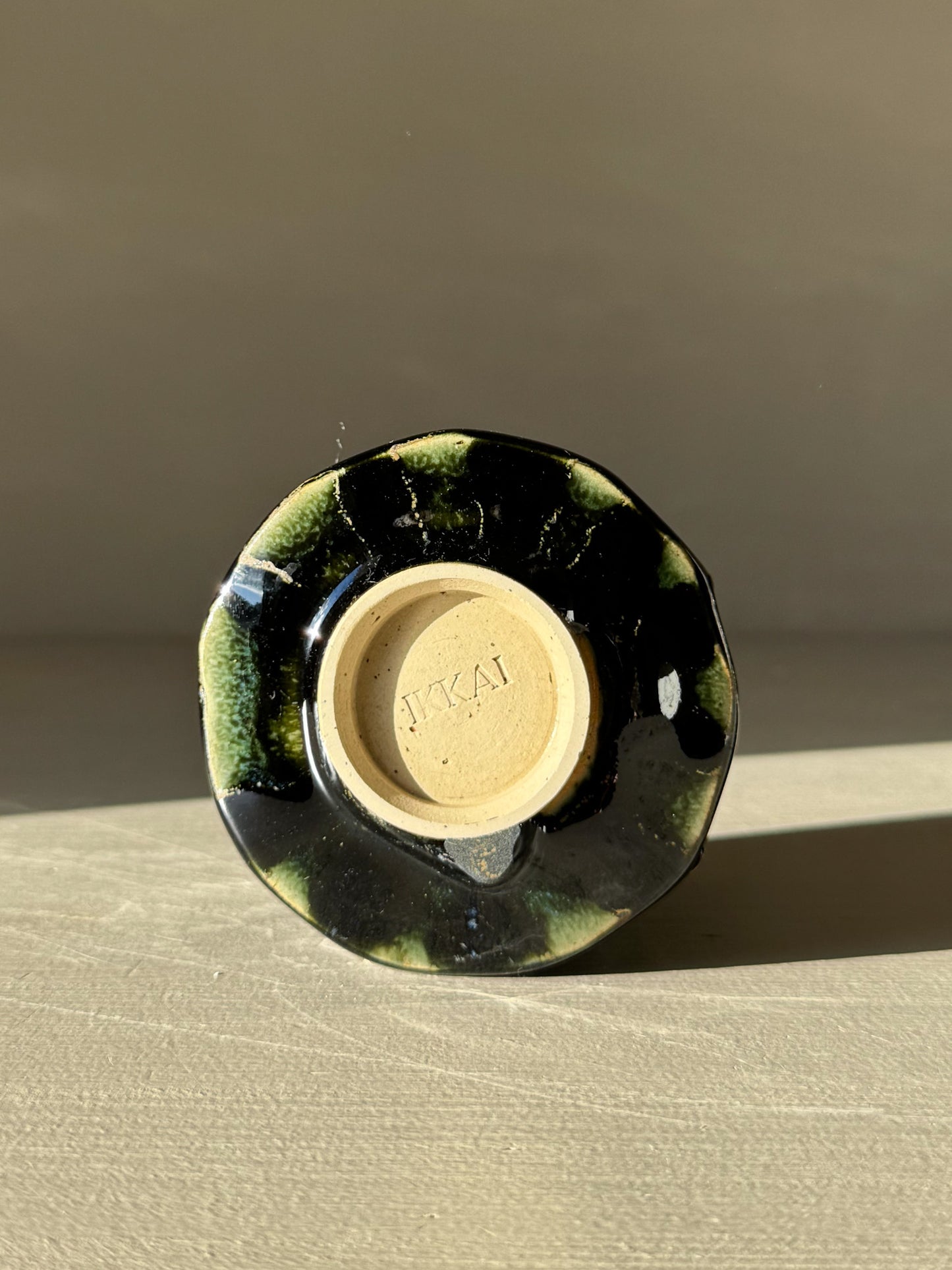 Bottom view of Yunomi Cup - Hinoki #13 showcasing deep green glaze and unique texture from the Hinoki Series.