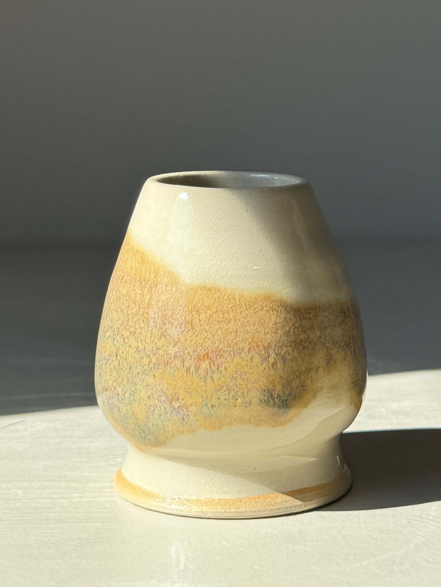 Handmade Matcha whisk holder in clear glaze with tenmoku splashes, designed to preserve and dry bamboo whisks effectively.
