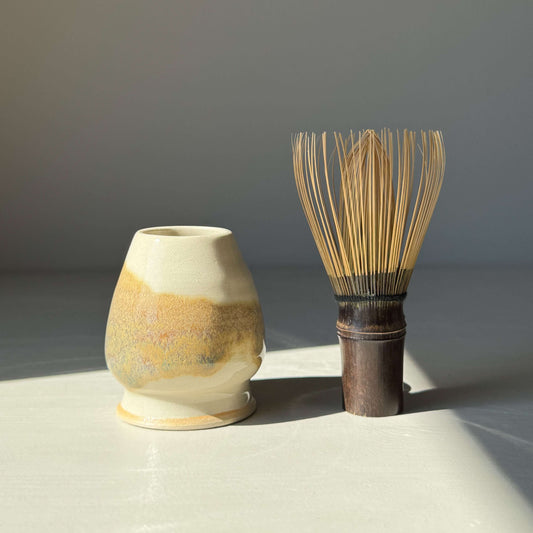 Handmade ceramic Matcha Whisk Holder - Clear Glaze & Tenmoku with bamboo whisk, showcasing unique earthy tones and glossy finish.