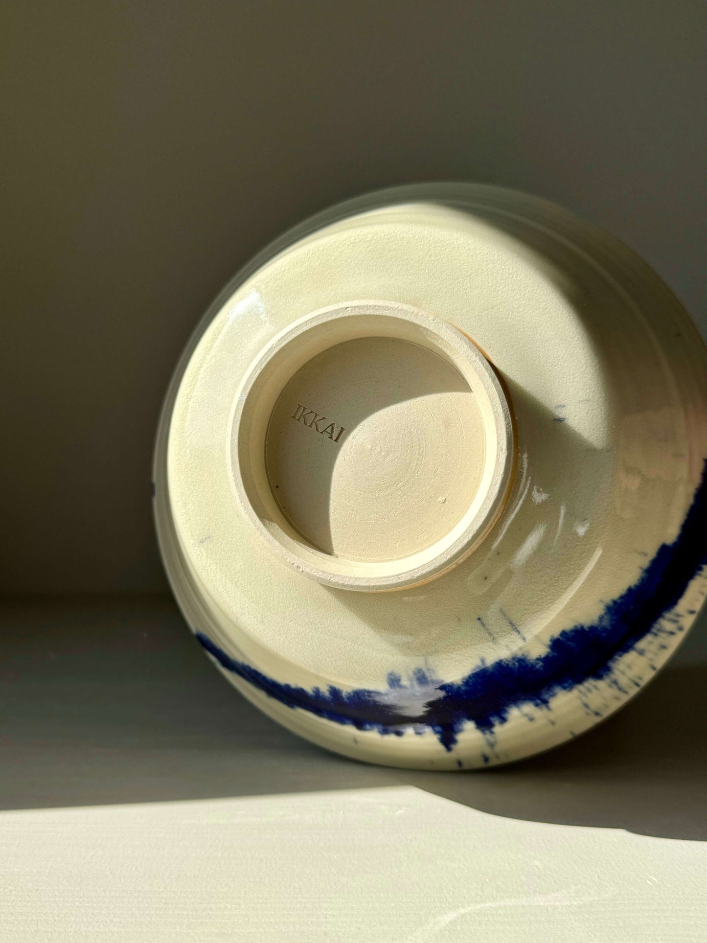 Underside view of the Gosu Series #03 serving bowl with Japanese-inspired design and blue brushstroke pattern on tall foot.