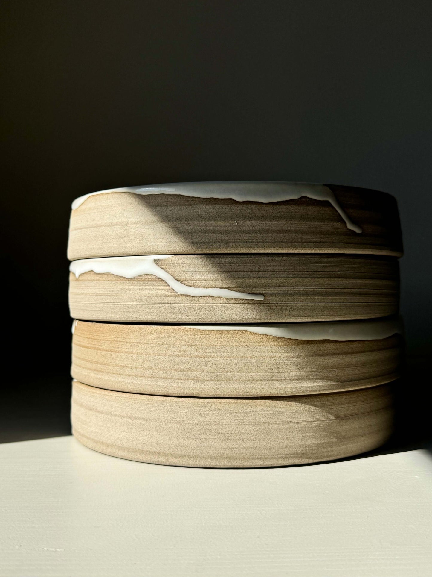 Stack of Large Plate – Yuki Series: handmade ceramic plates with toffee-colored clay and glossy white glaze.