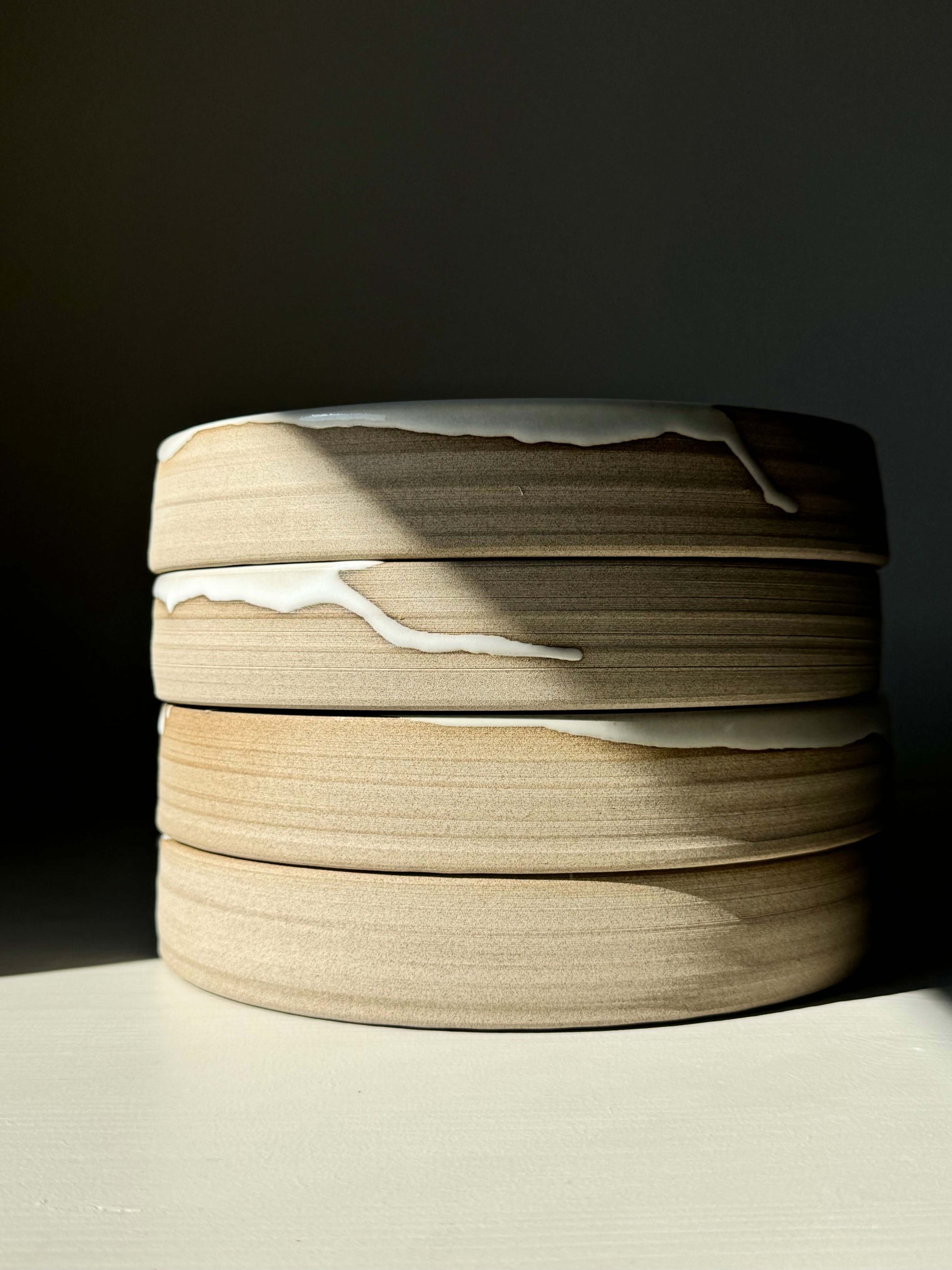 Stack of Large Plate – Yuki Series: handmade ceramic plates with toffee-colored clay and glossy white glaze.