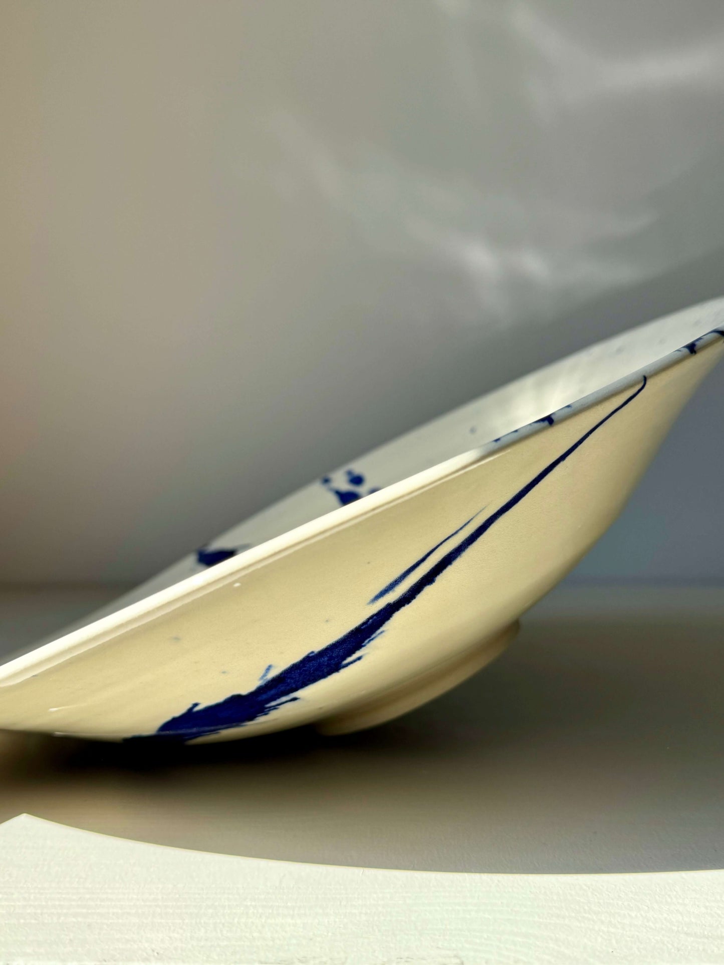 Side view of Large Shallow Bowl from the Gosu Series, showcasing its elegant shape and blue design on durable stoneware.