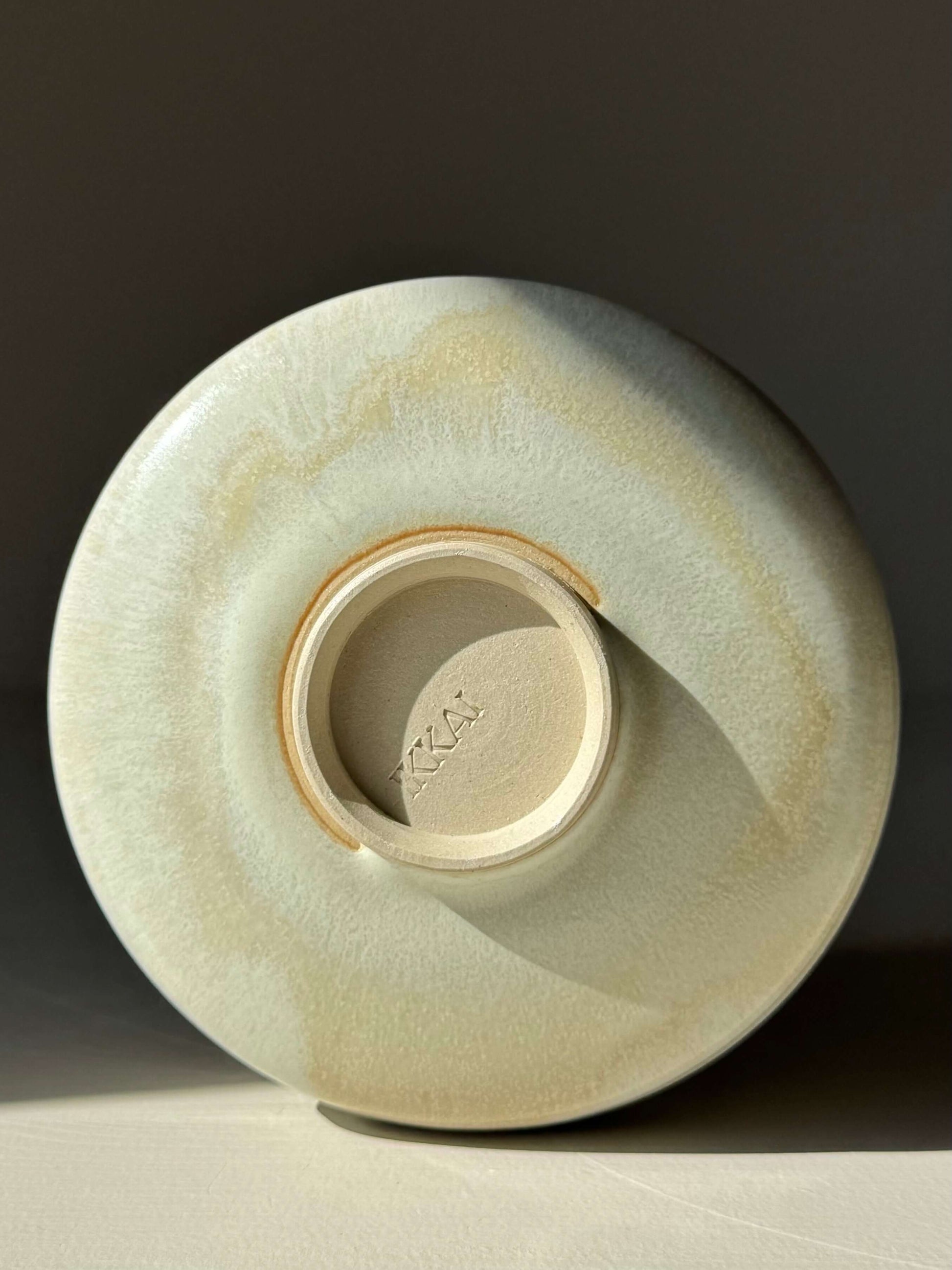 Base view of handmade ceramic Matcha Bowl – Moonstone Glaze with ridged shape, showcasing the silky, light-catching finish.