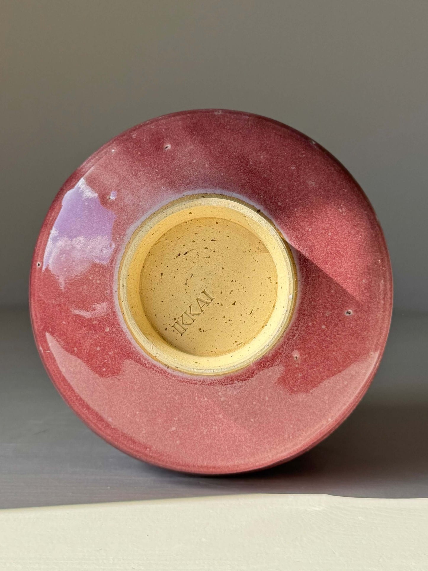 Bottom view of Matcha Bowl - Ume Series #05, a handmade ceramic with red glaze and trimmed foot, inspired by Japanese Ume blossom.