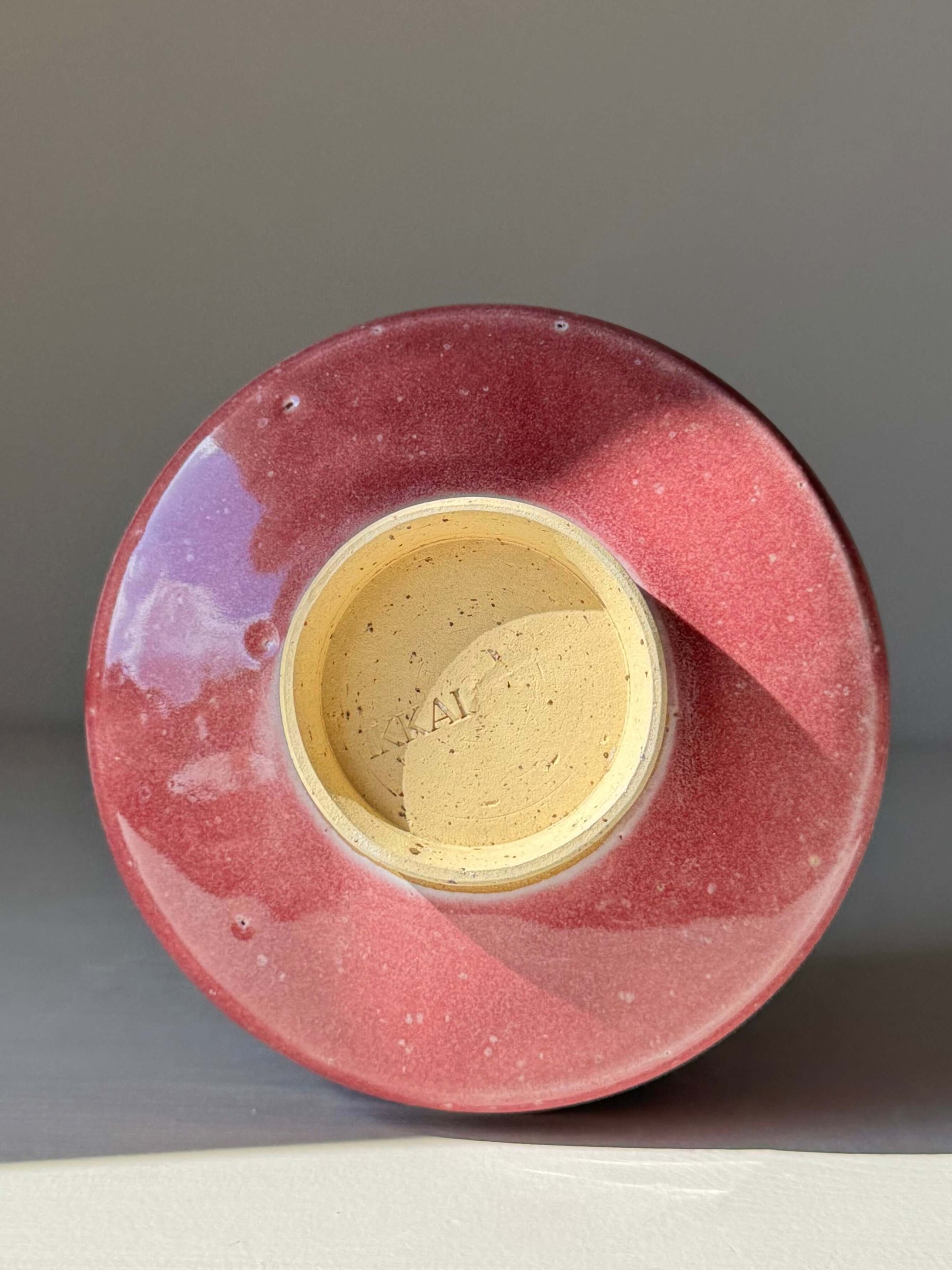 Bottom view of the handmade ceramic Matcha Bowl - Ume Series #06, showcasing the sculptural design and rosy hue inspired by Ume blossom.