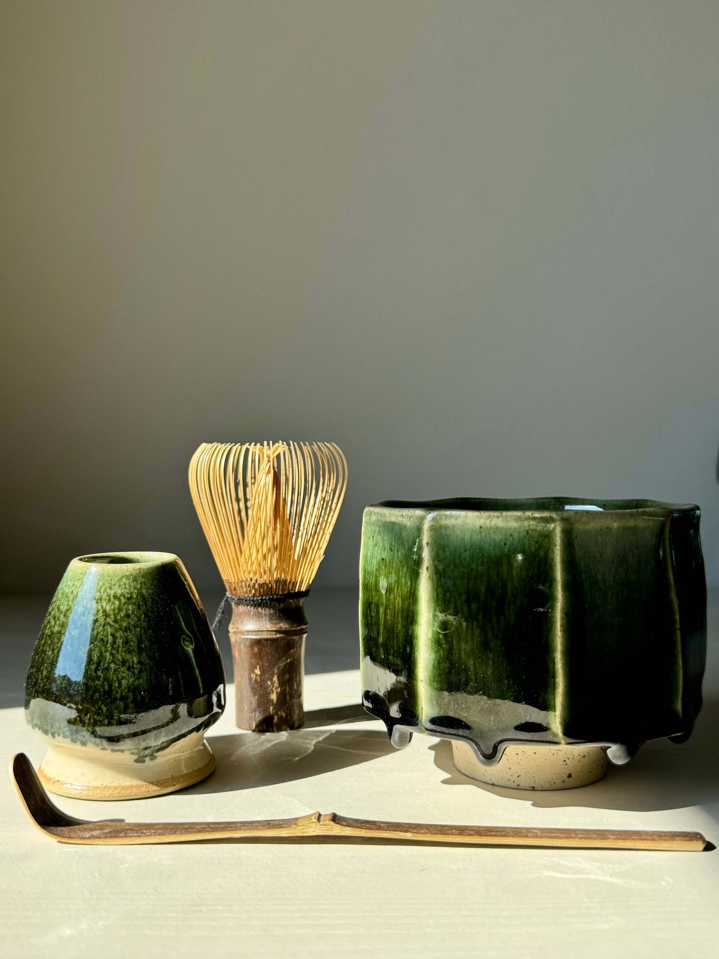 Green glazed Matcha whisk holder from Hinoki Series with bamboo whisk and accessories, embodying balance and tranquility.