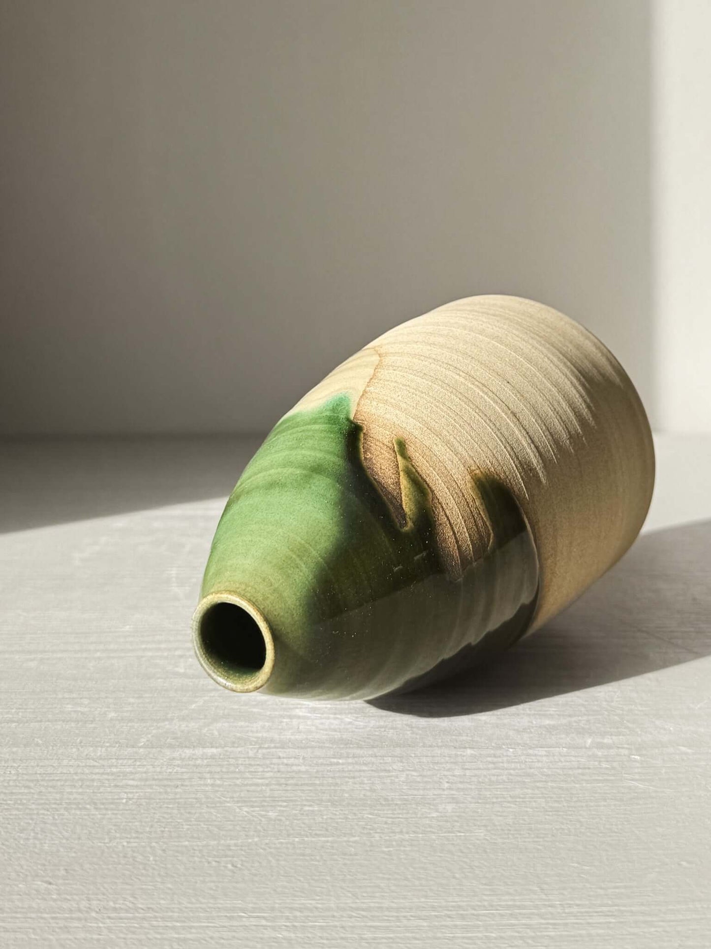 Medium Vase – Mori #01 featuring a gentle green glaze on warm clay with a tall, rounded shape and narrow opening, ideal for home decor.